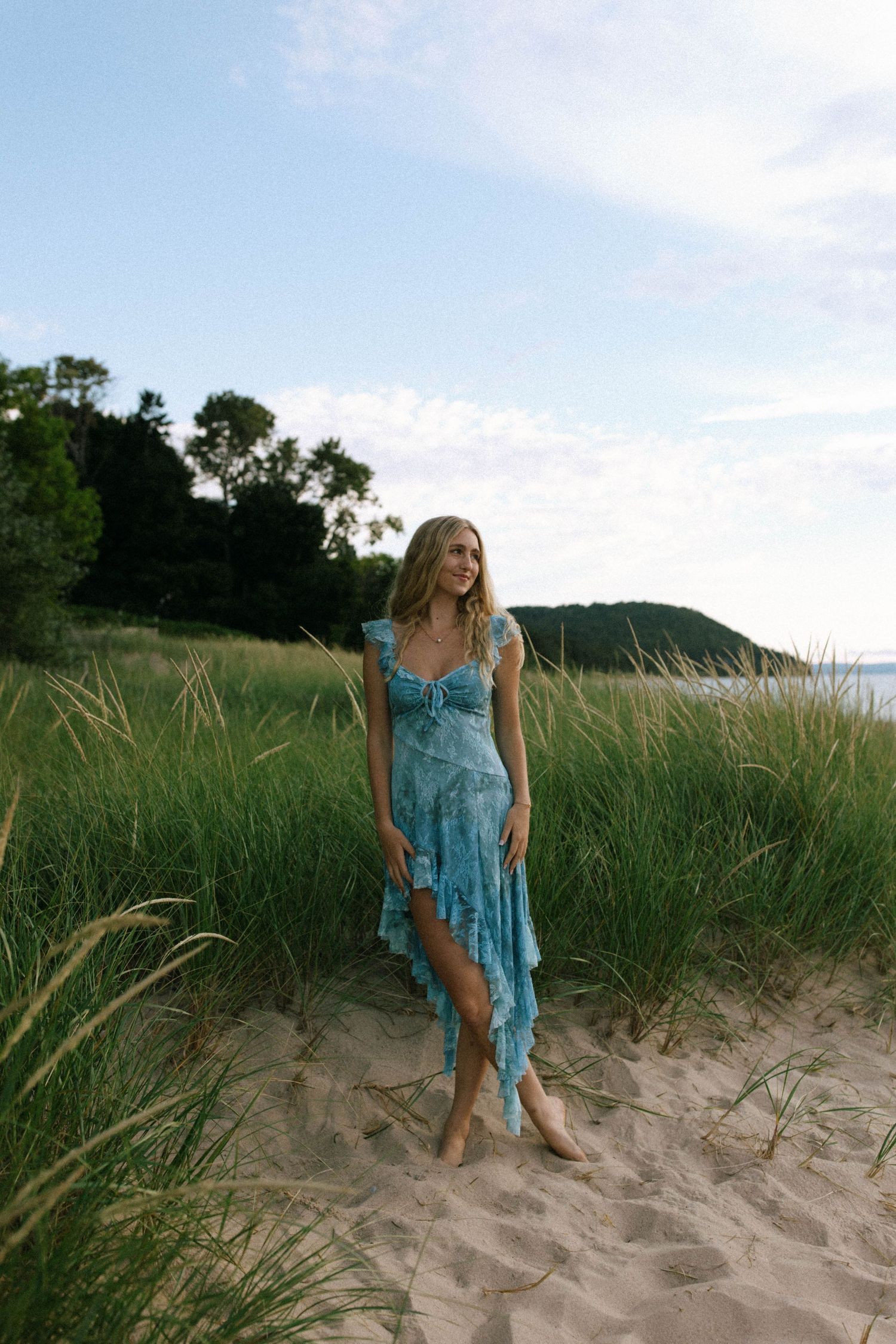 Turquoise summer dress styled against beach dunes and tall grass.