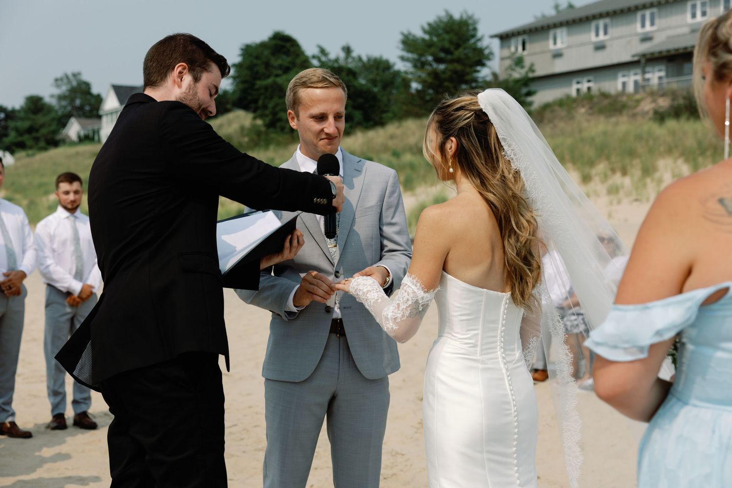 Wedding celebration candid moments on a sunny beach with guests.