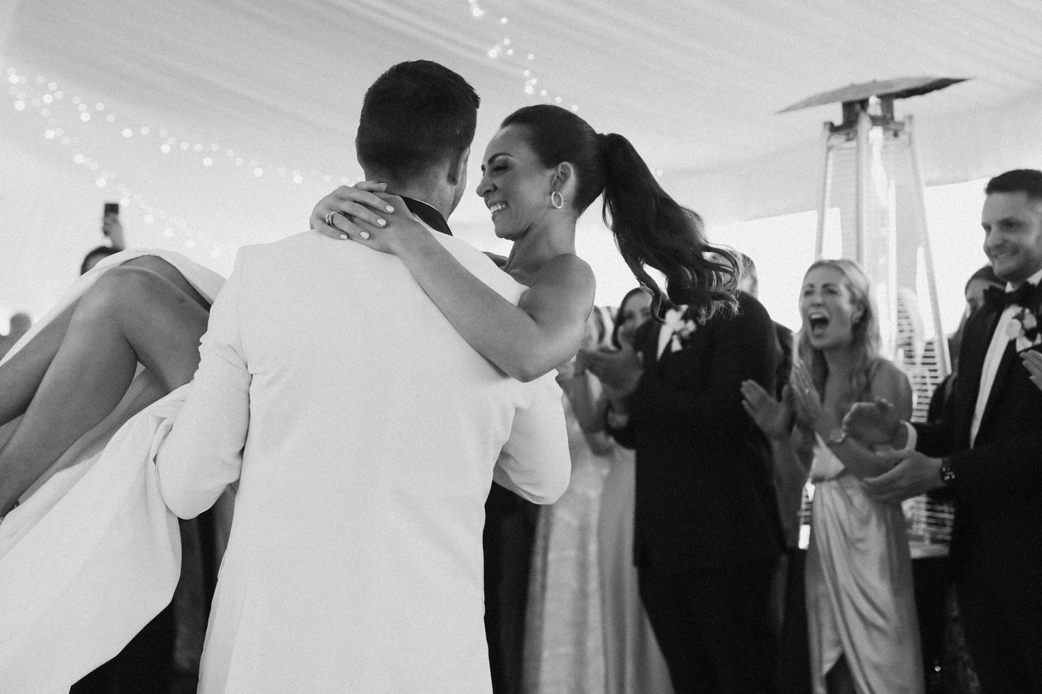 Intimate dance moments captured during elegant tented wedding reception.