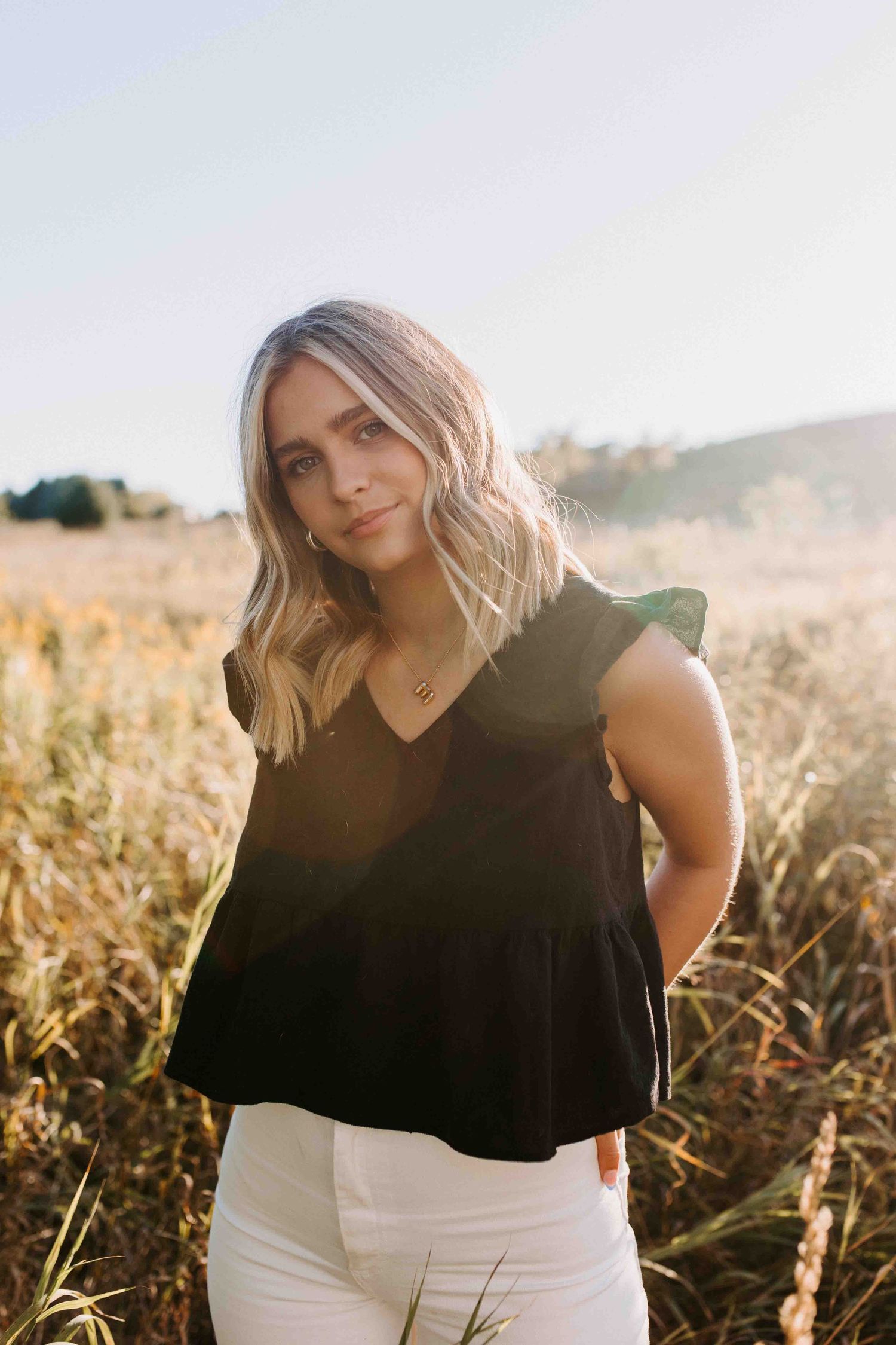 Outdoor fashion portraits in a field during golden hour.