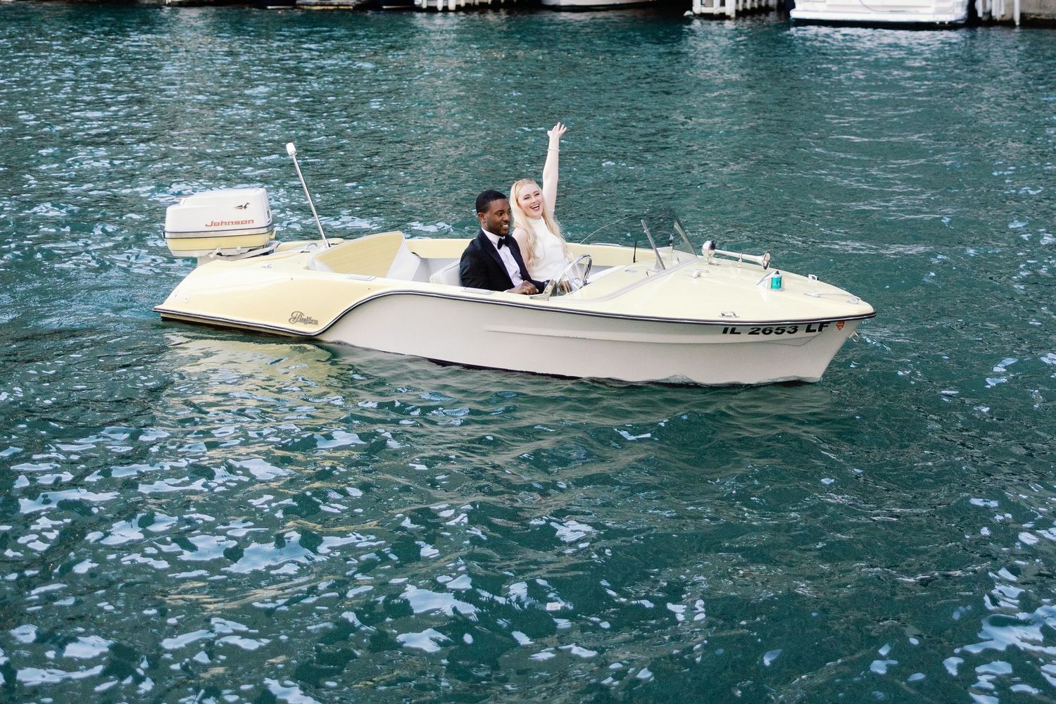 A line of white boats docked at a marina with turquoise water creating a serene nautical scene.