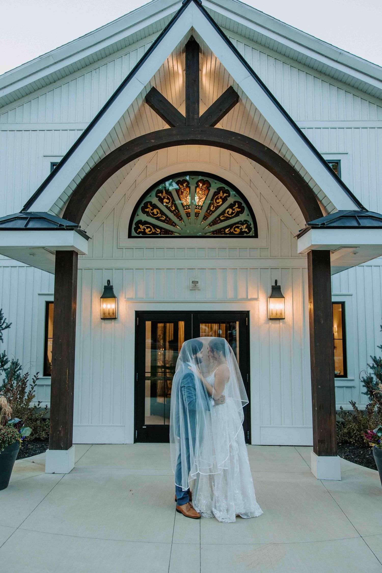 Series of wedding photos showing couple in front of white chapel with stained glass windows.