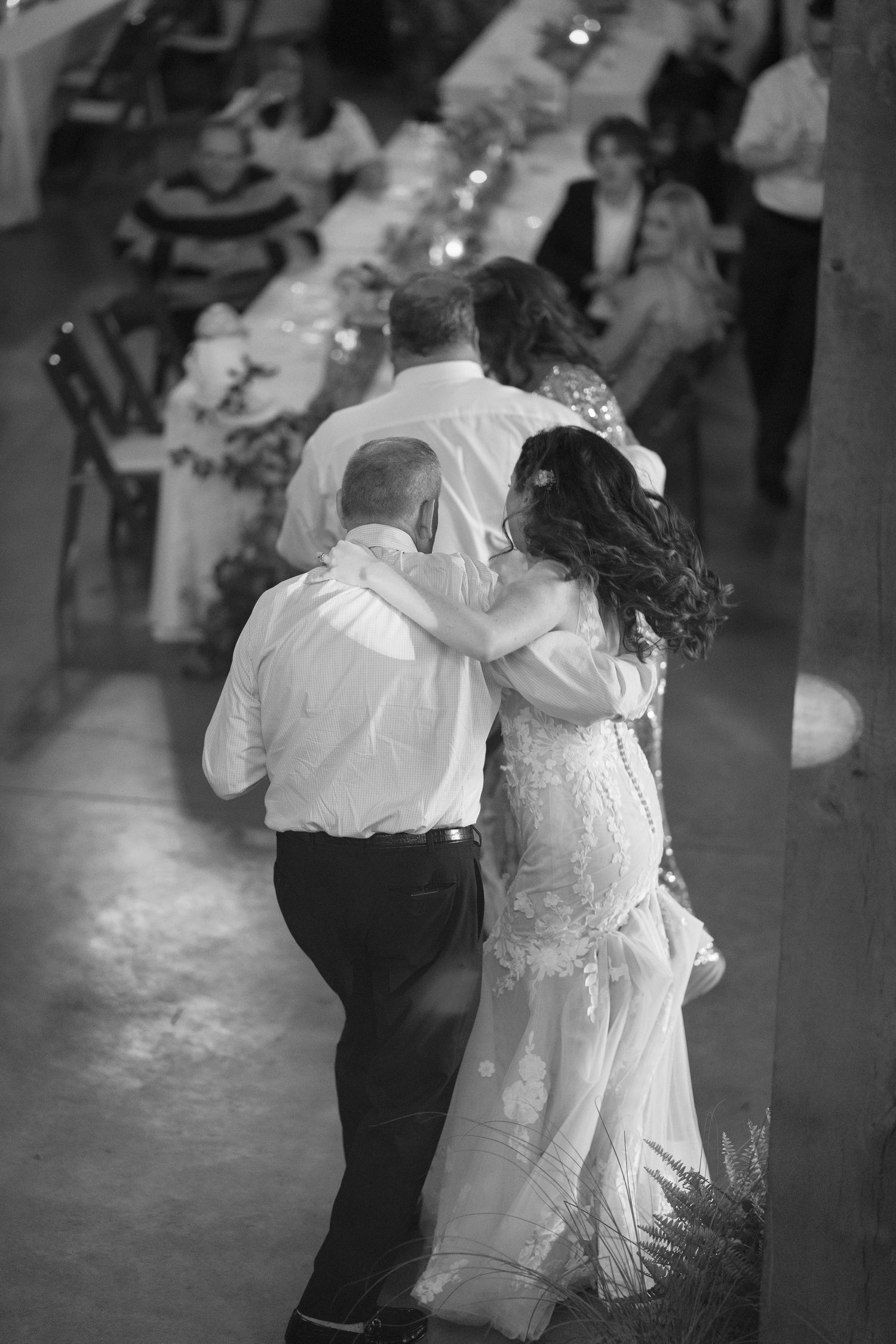 Black and white photo of couples dancing at a wedding reception.