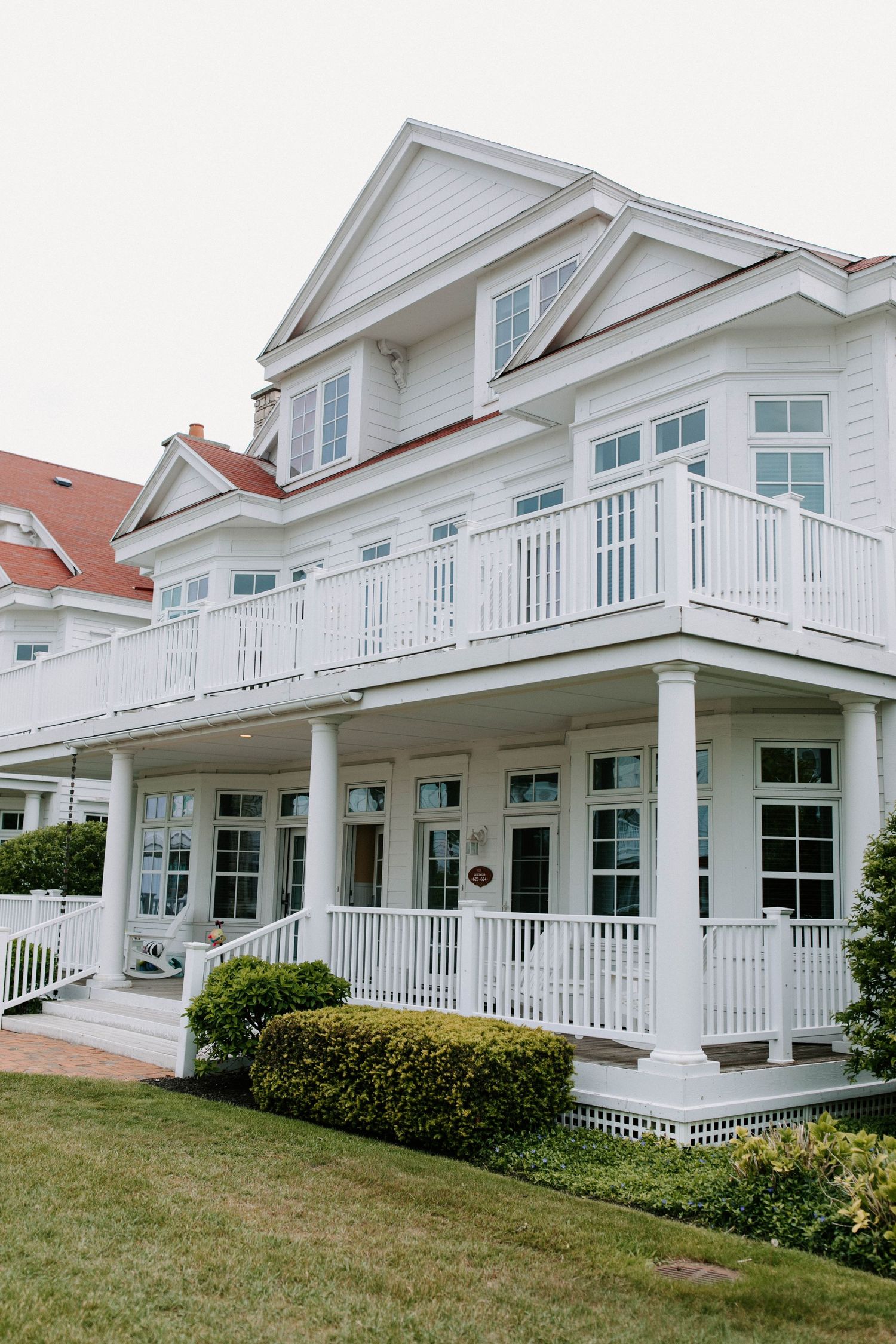 Elegant white beach houses with wraparound porches and classic colonial architecture.
