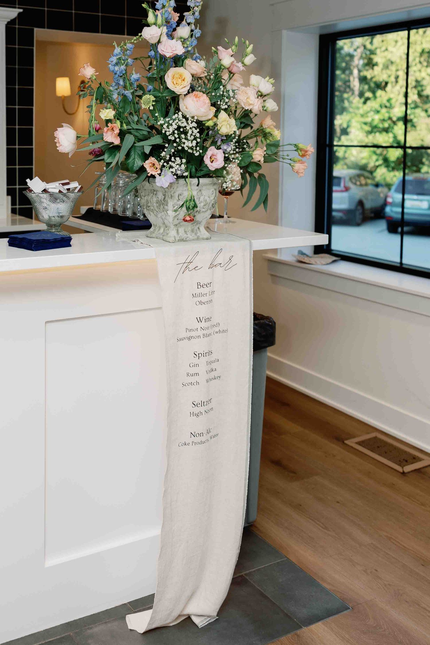Modern wedding venue interior with elegant floral arrangements and signage.