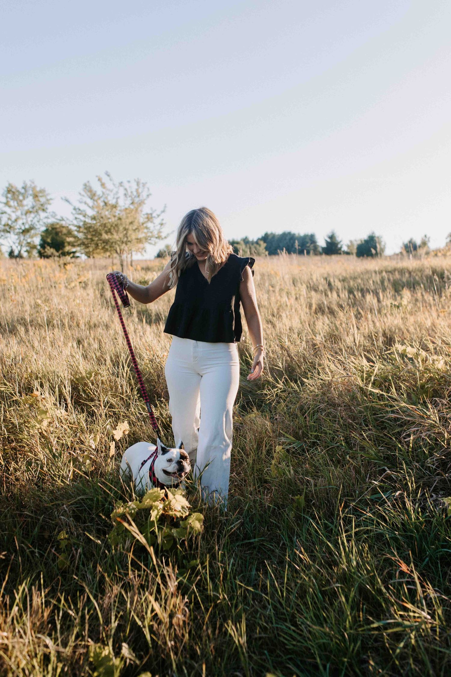 Exploring a golden field at sunset in casual attire.