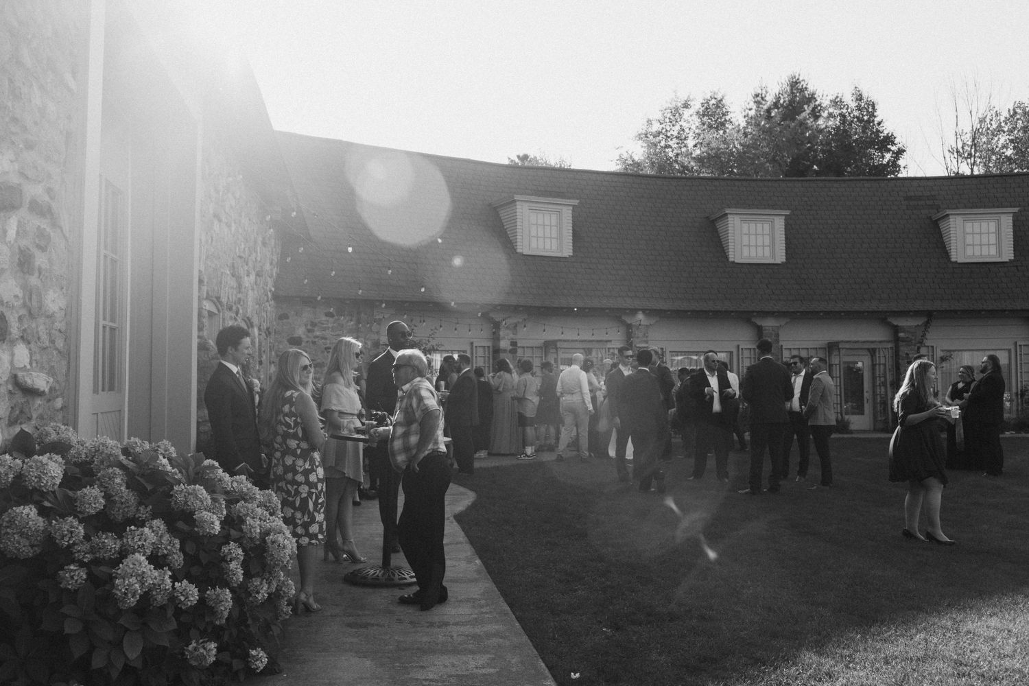 Black and white film strip showing outdoor wedding reception scenes at dusk.