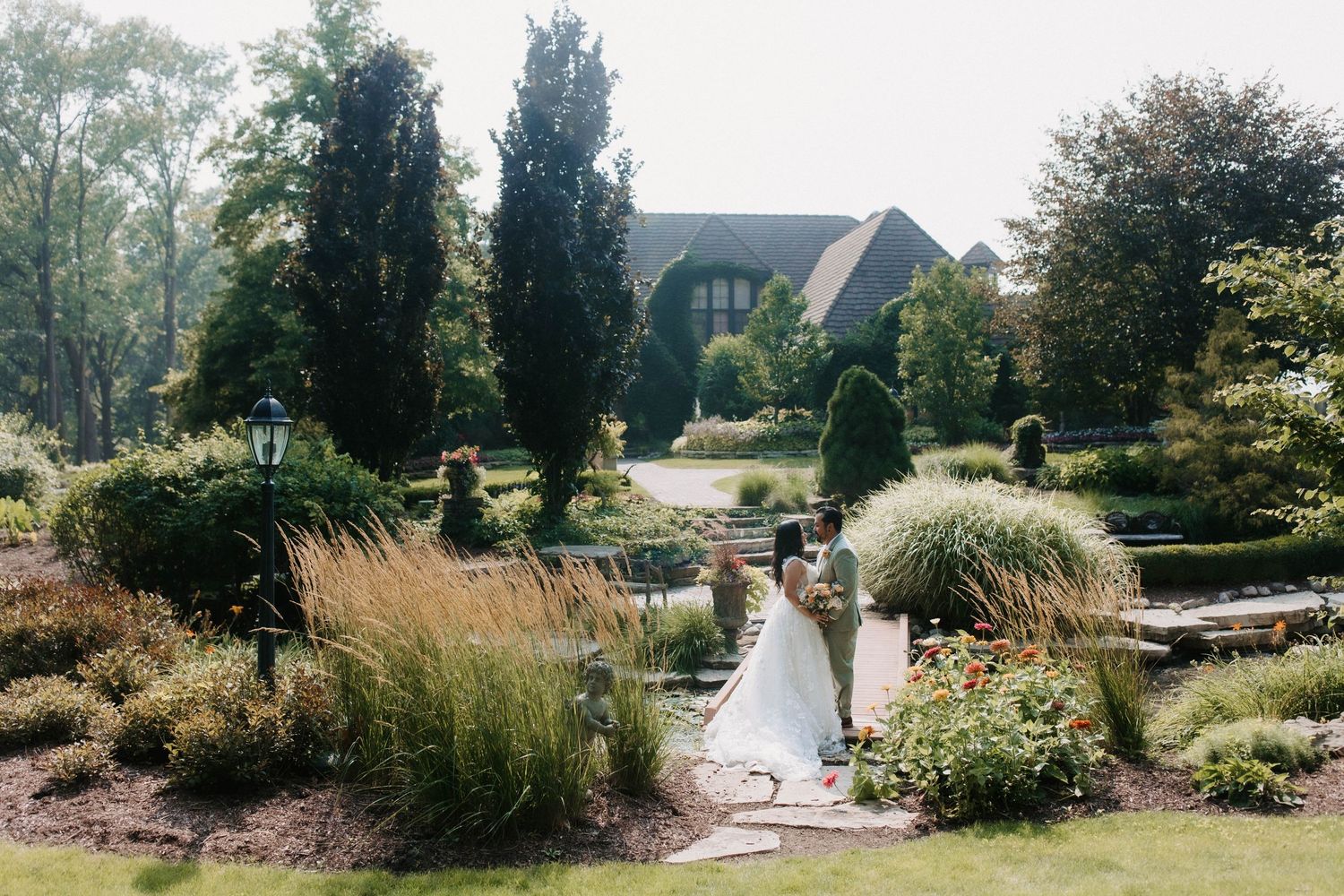 Beautiful garden landscape with ornamental grasses and flowering plants in a manicured setting.