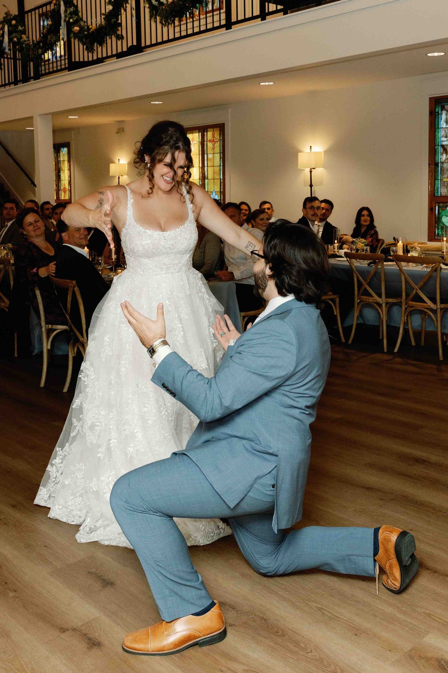 Wedding couple performing a dramatic dance move sequence in sepia tones.