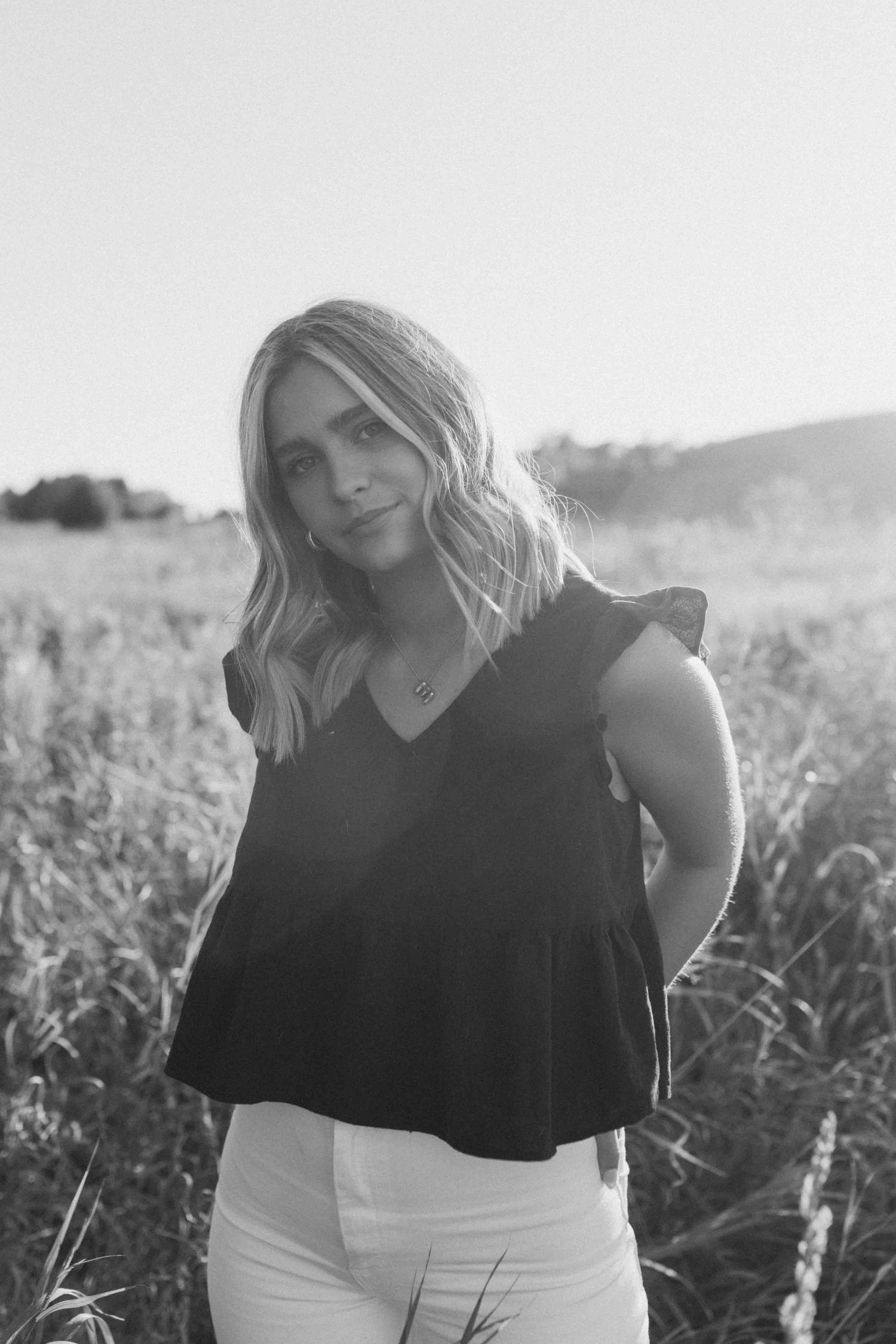 Black and white portraits in a natural field setting.