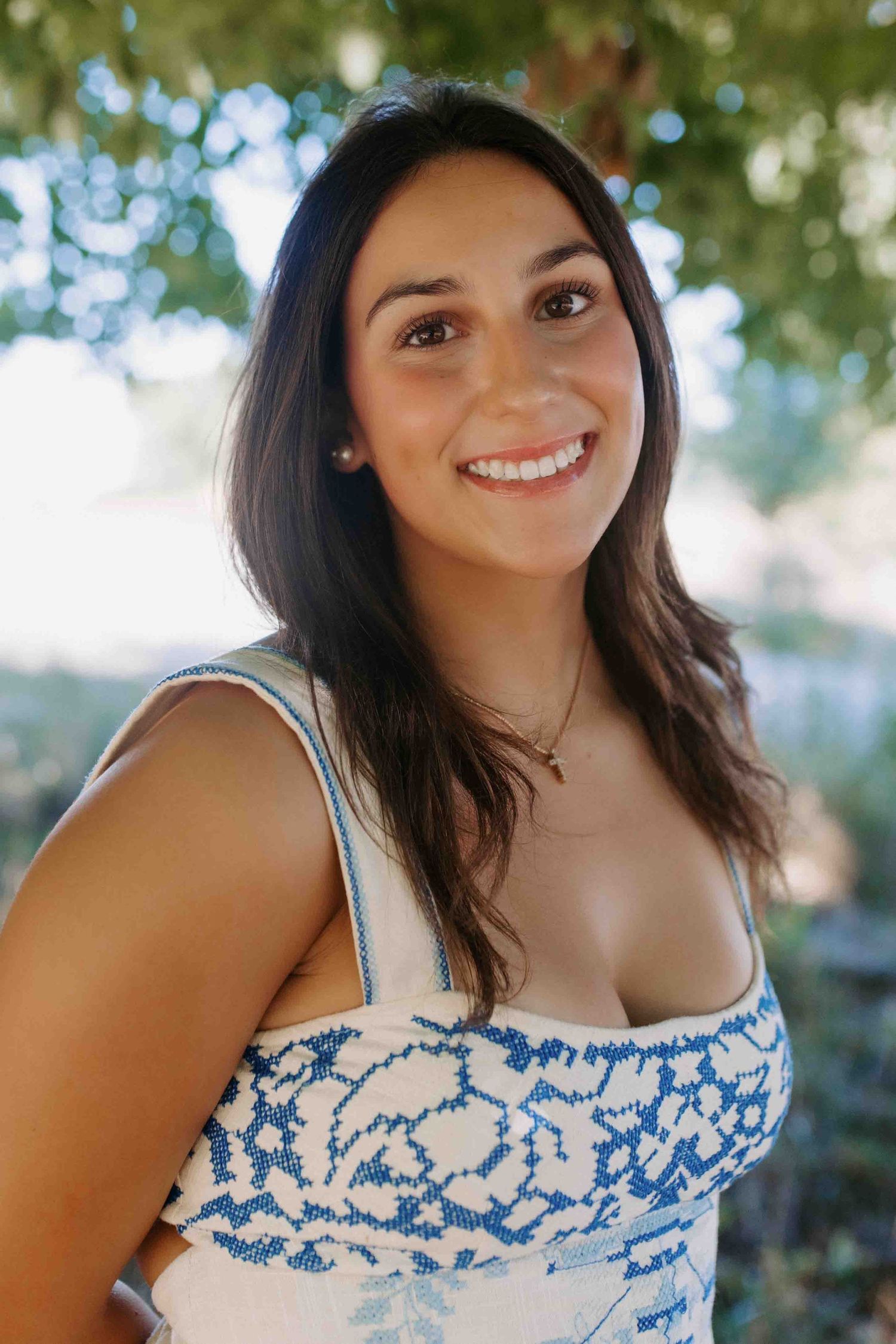 Summer portrait series showing genuine smiles and casual poses under tree canopy.