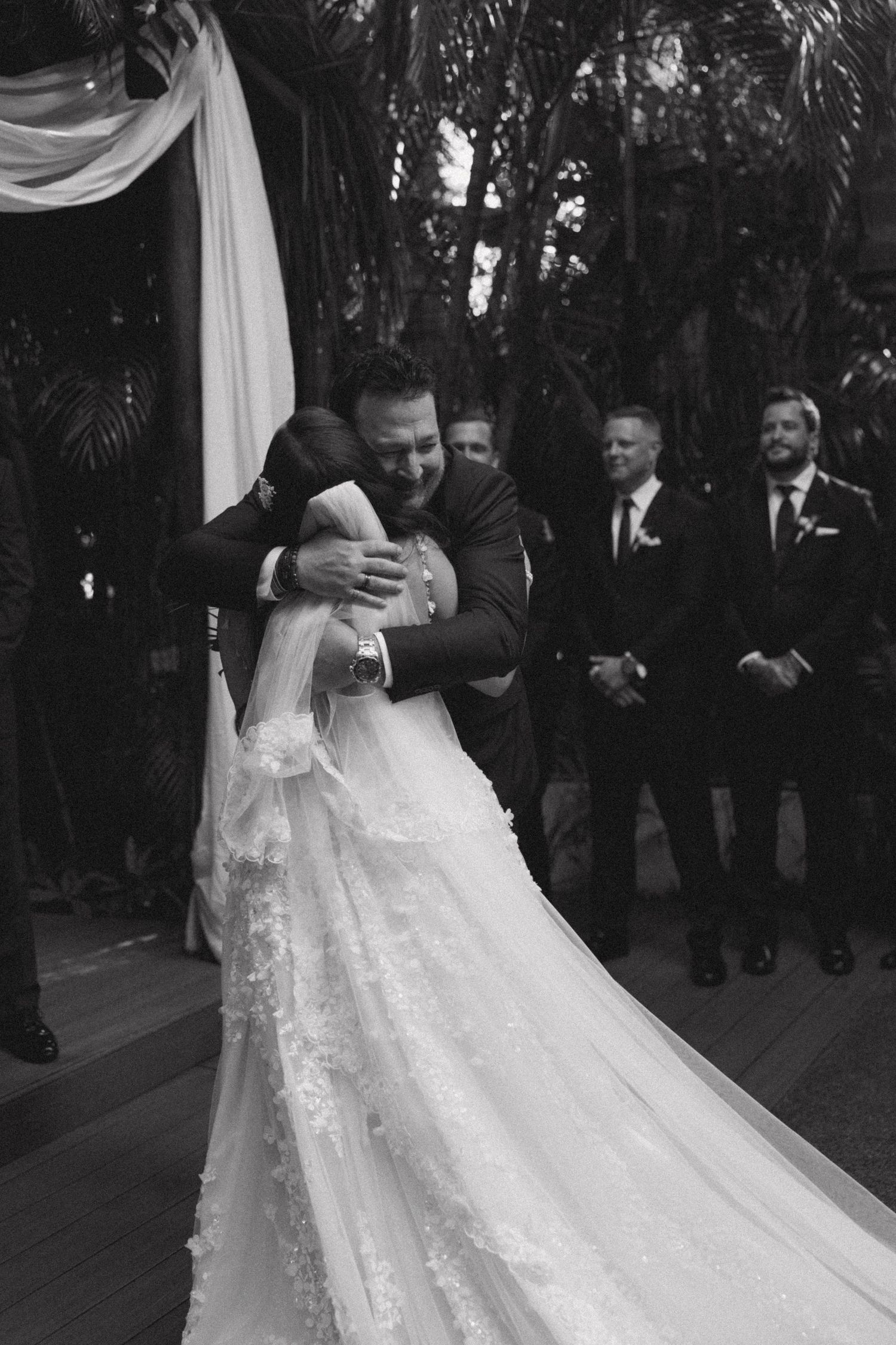 Couple shares their first dance on an outdoor wedding reception dance floor.