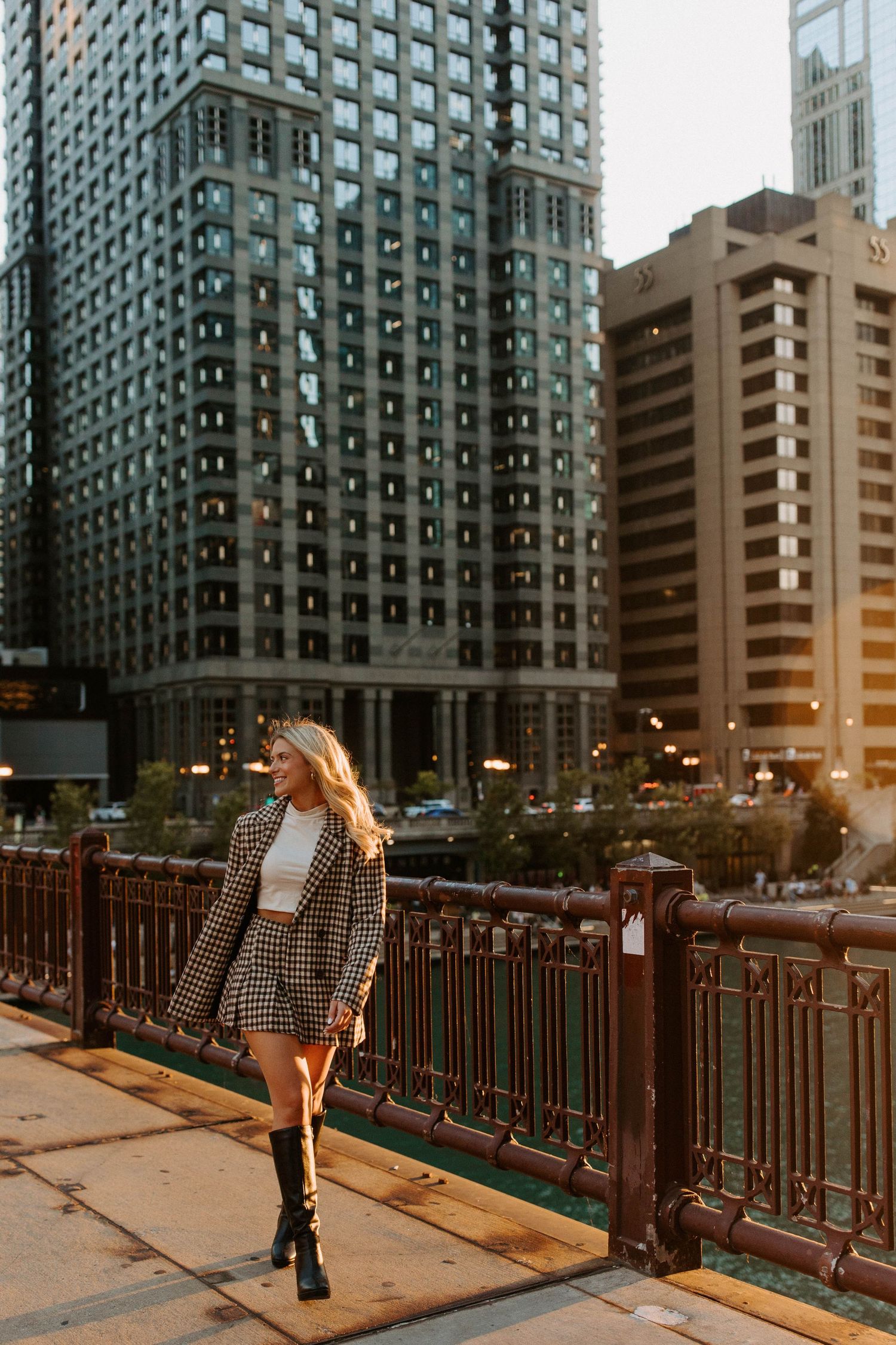 A sequence of photos showing a person walking across an urban bridge at sunset with tall buildings in the background.
