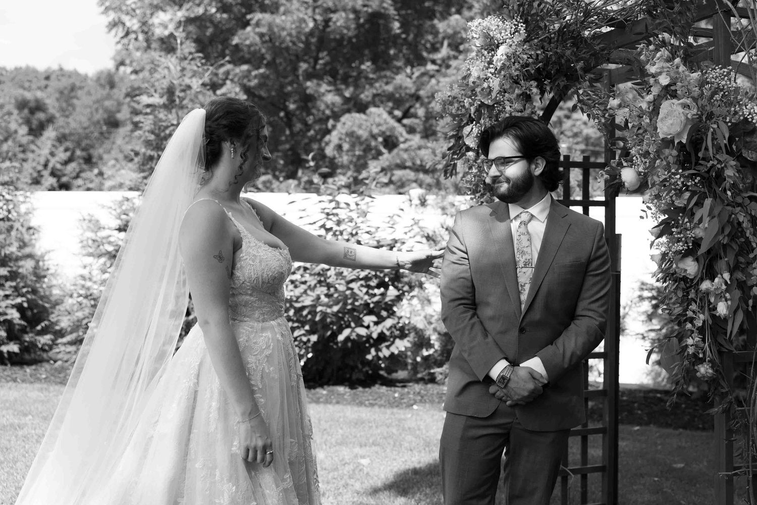 Black and white outdoor wedding photography sequence showing candid moments.