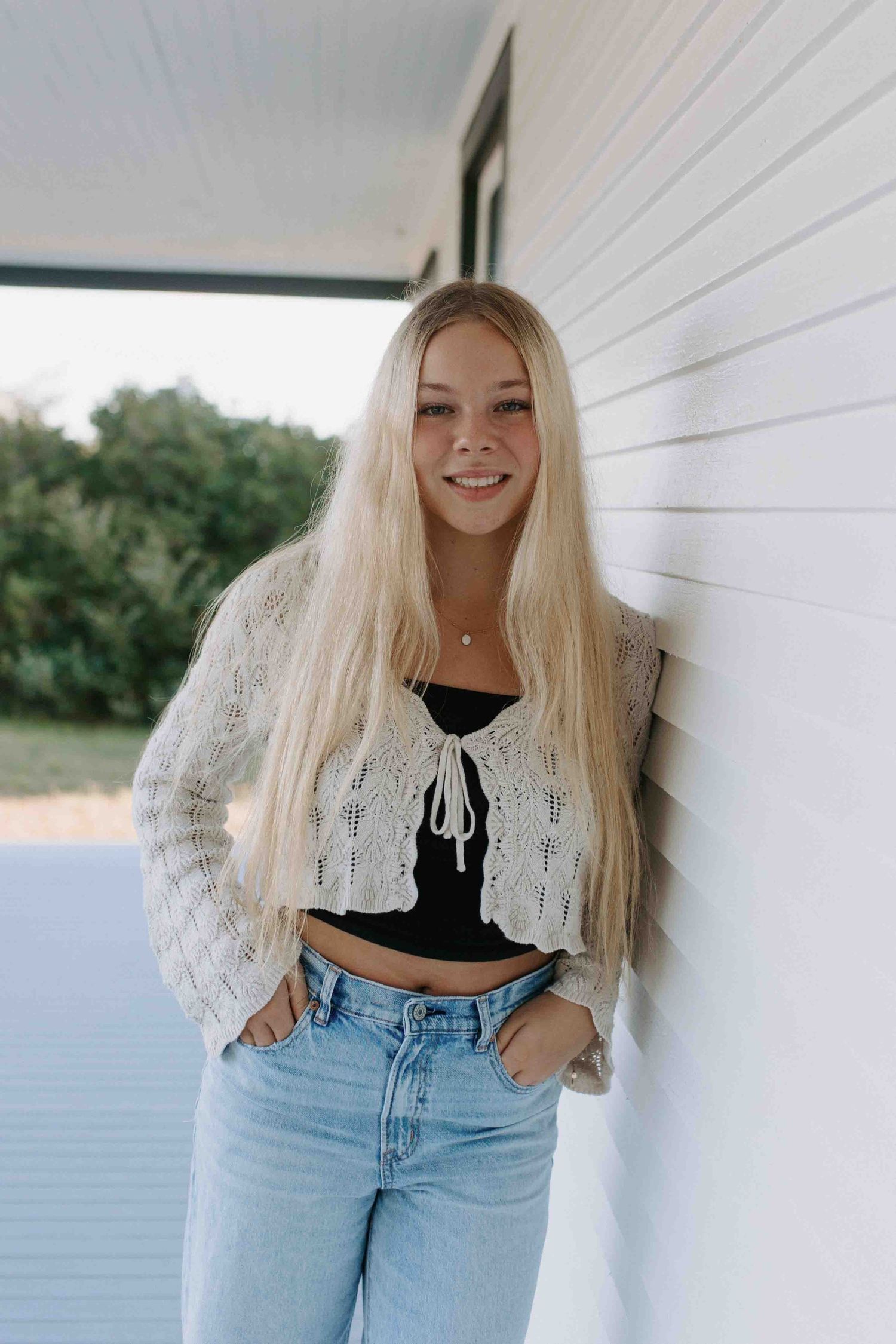 Lifestyle portraits against white wall showing trendy casual outfit.
