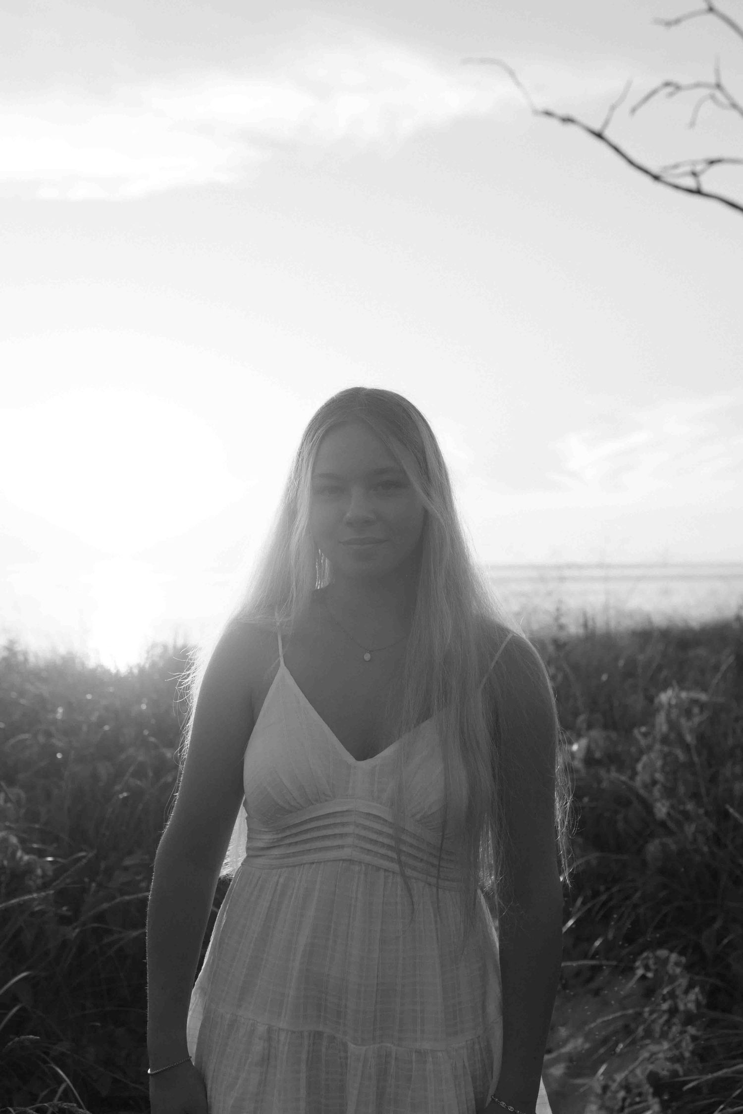 Dreamy black and white portrait taken in a field on an overcast day.