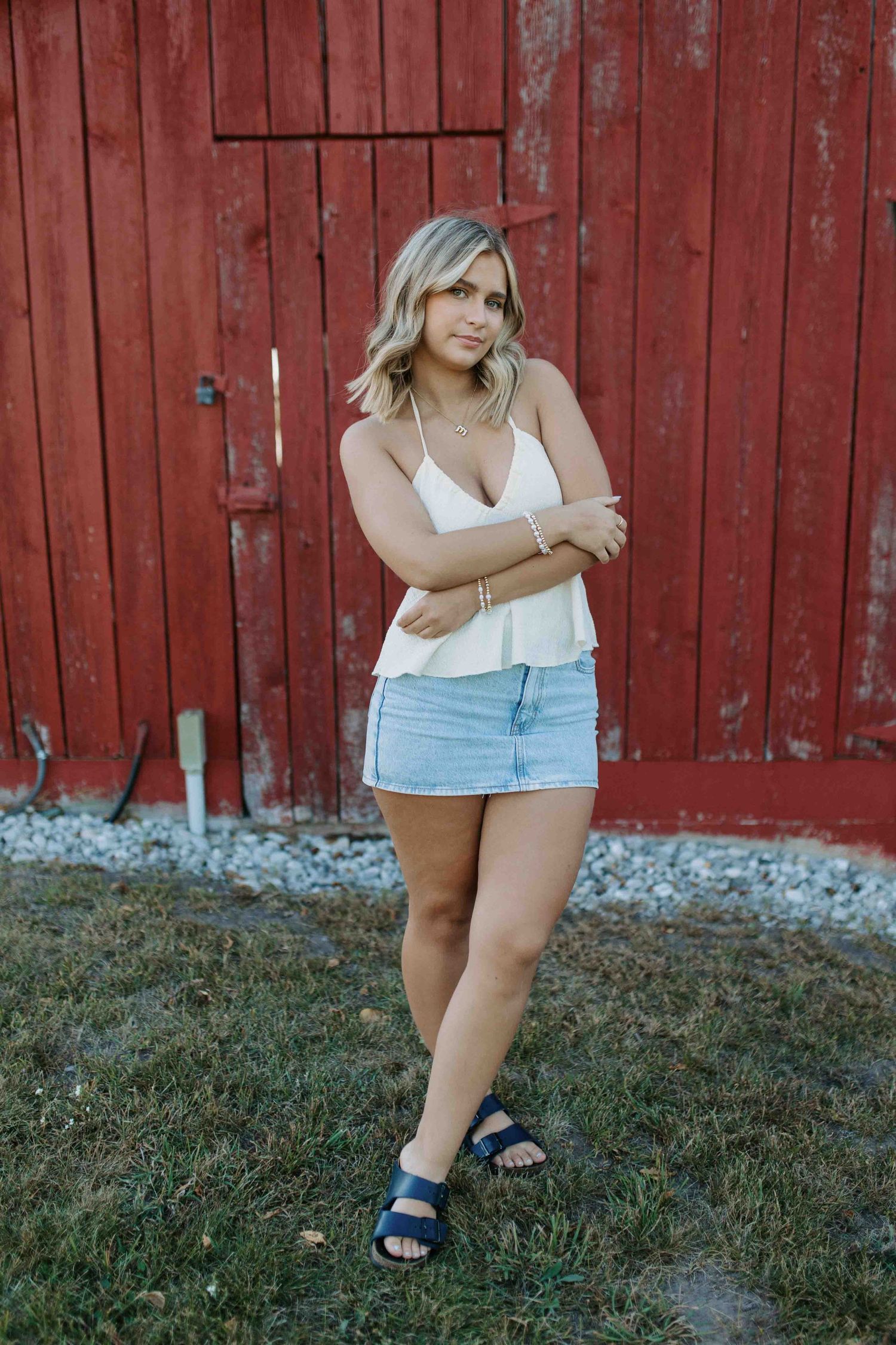 Casual summer look photographed against rustic red barn siding.
