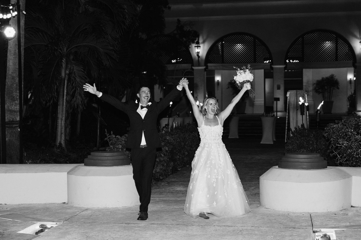 Wedding couple dances together during their first dance at an elegant evening reception celebration.