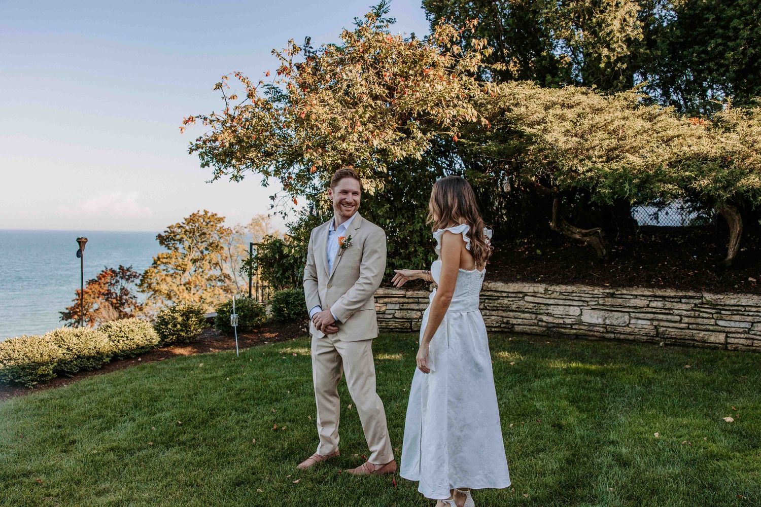 Engagement photos of a couple in formal attire posing in a scenic outdoor garden setting.