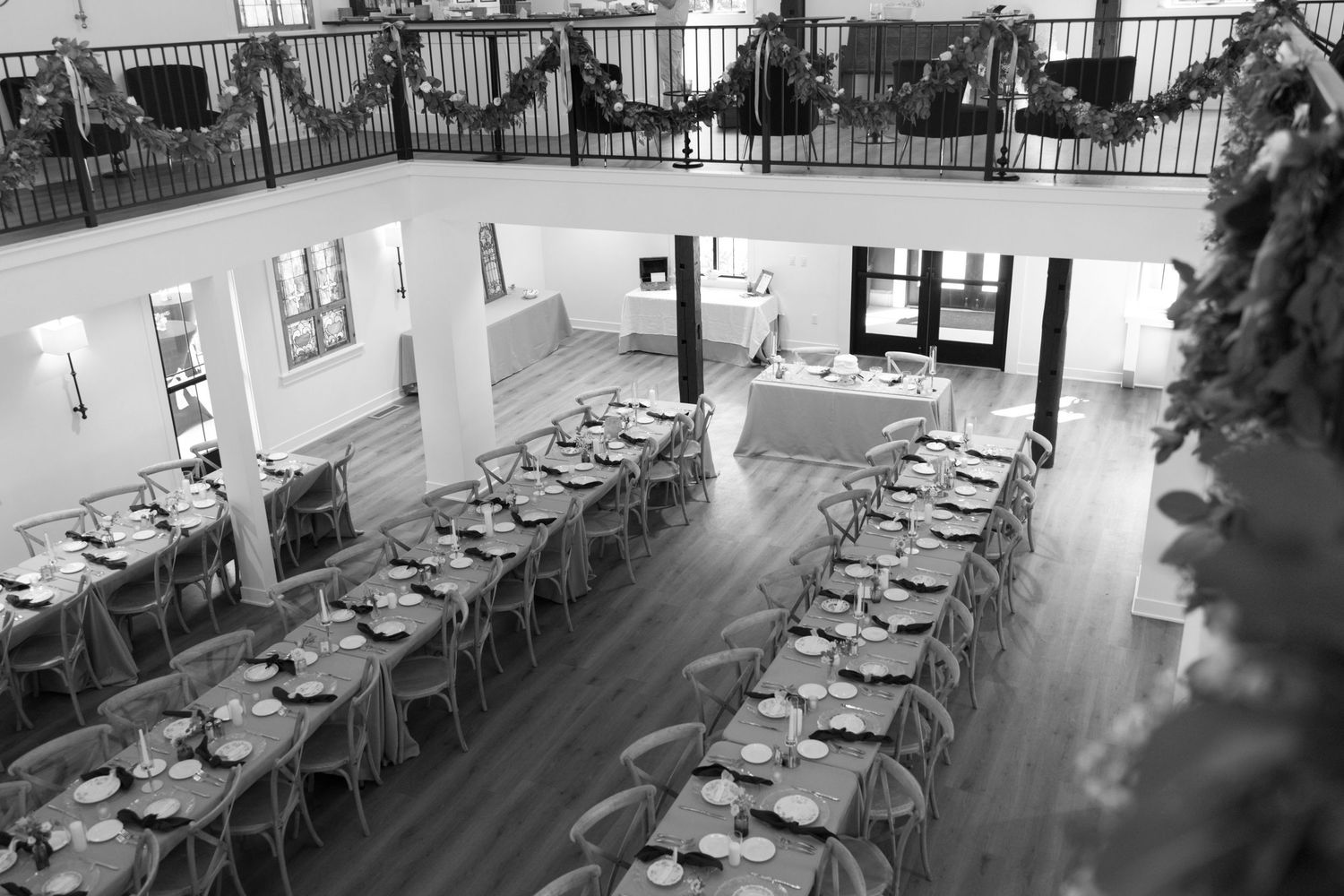 Empty white chairs arranged in rows inside a modern event venue.