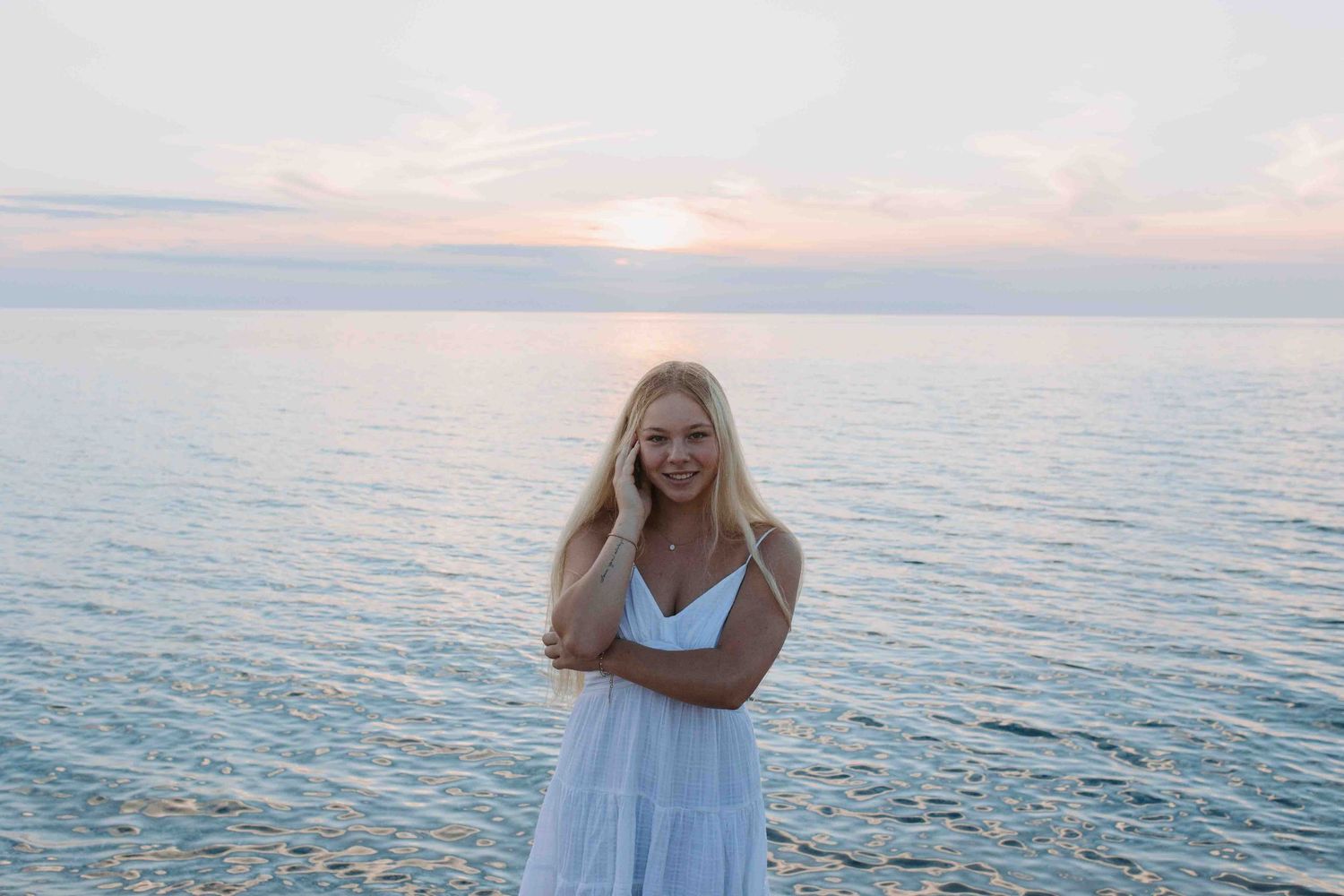 Fun and casual beach photography featuring someone in white against the ocean and mountains.