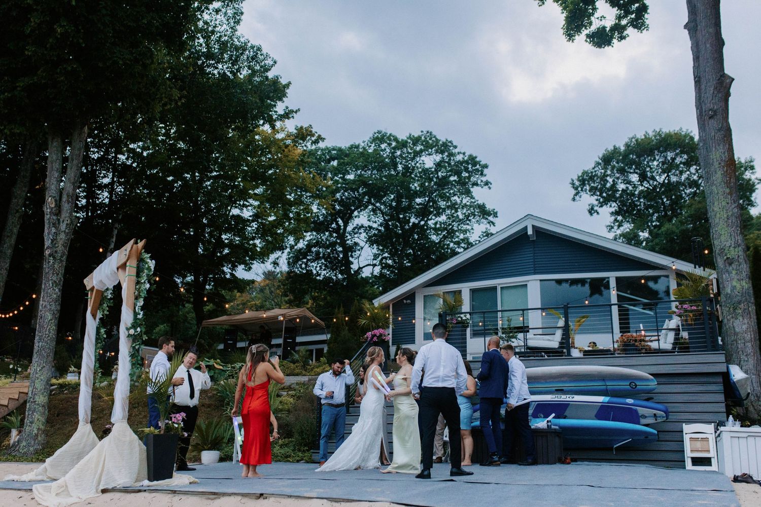 Outdoor wedding ceremony setup with white tents and chairs arranged on a lawn.