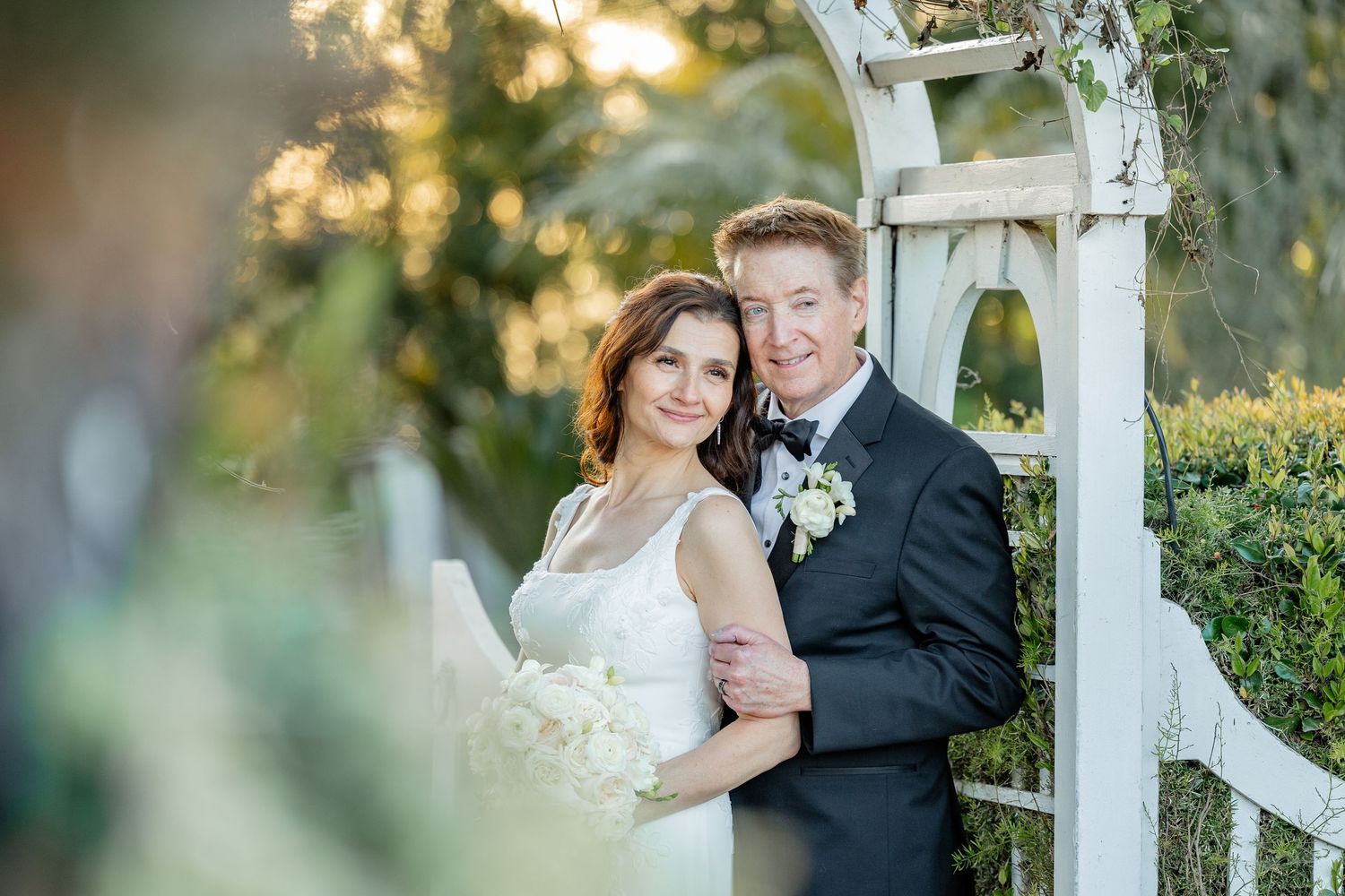 Bride and groom walking through the vineyards at Villa de Amore in Southern California during a romantic sunset wedding portrait session.