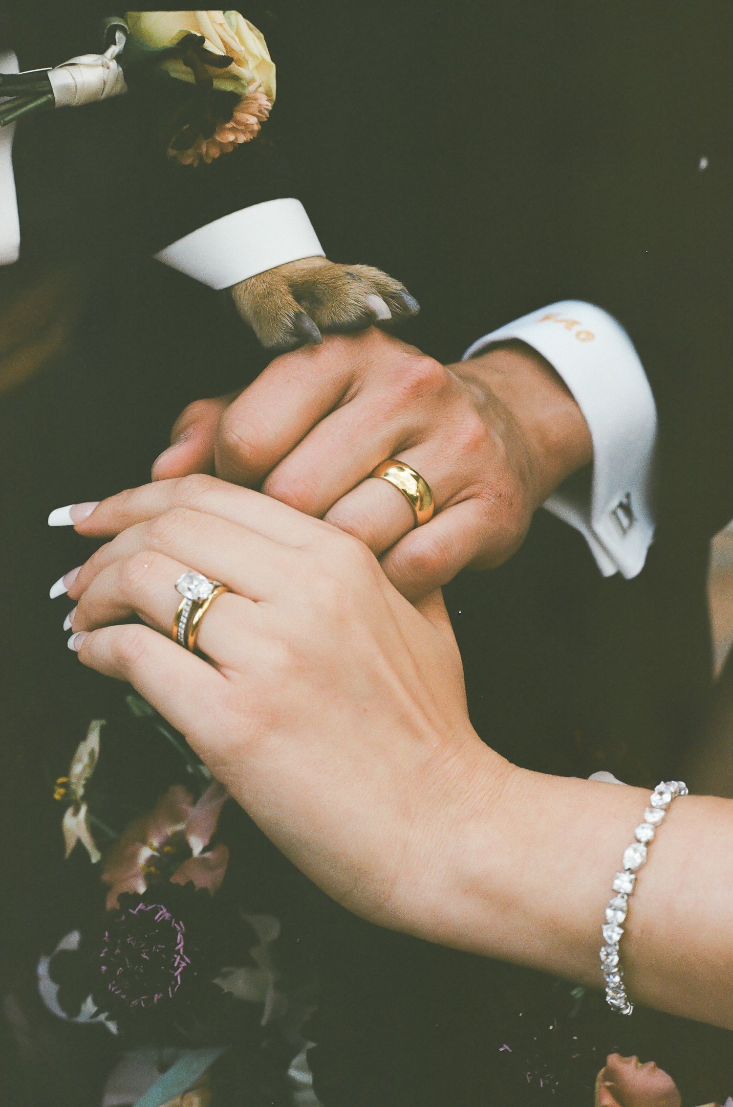 Close-up shots of hands wearing elegant jewelry including diamond rings and bracelets against a dark background.