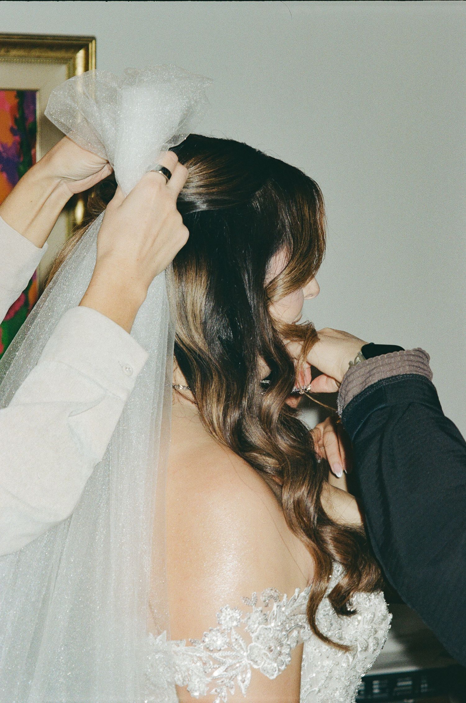 A romantic wedding moment captured in a series of four photos showing a couple sharing a kiss under a delicate white veil.