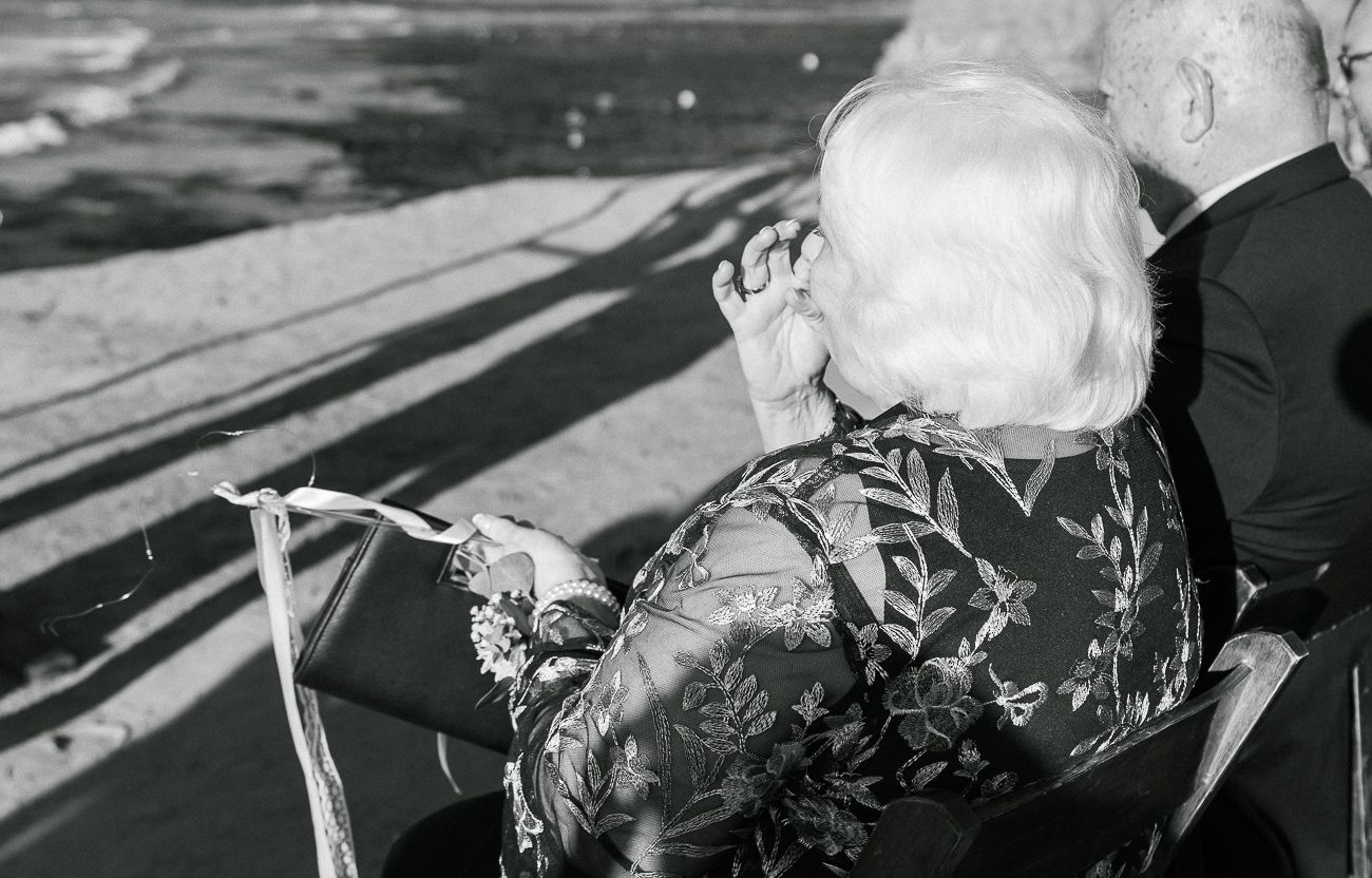 Vintage black and white photo of someone viewing the ocean from a seaside vantage point.