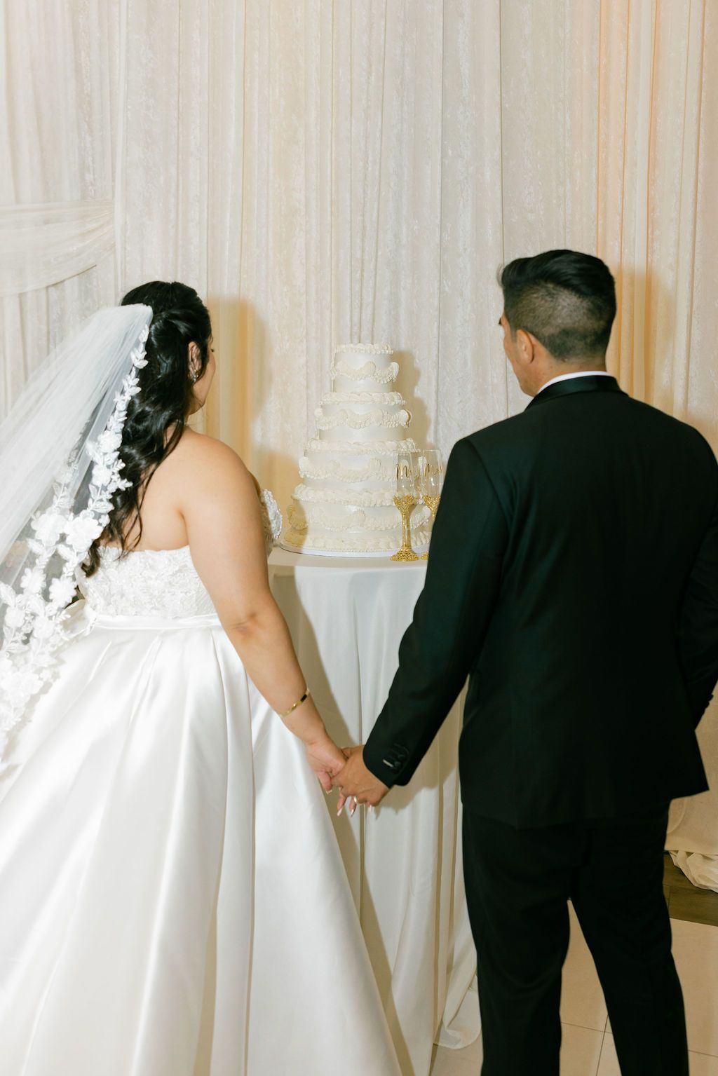 A series of wedding photos showing a bride in white dress and groom in black suit from behind in elegant settings.