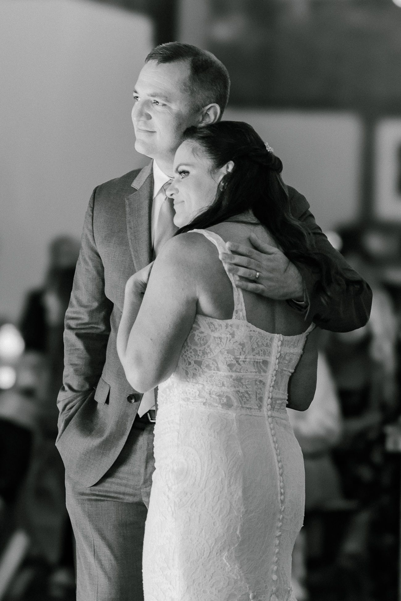 An intimate black and white dance moment captured during a wedding reception.