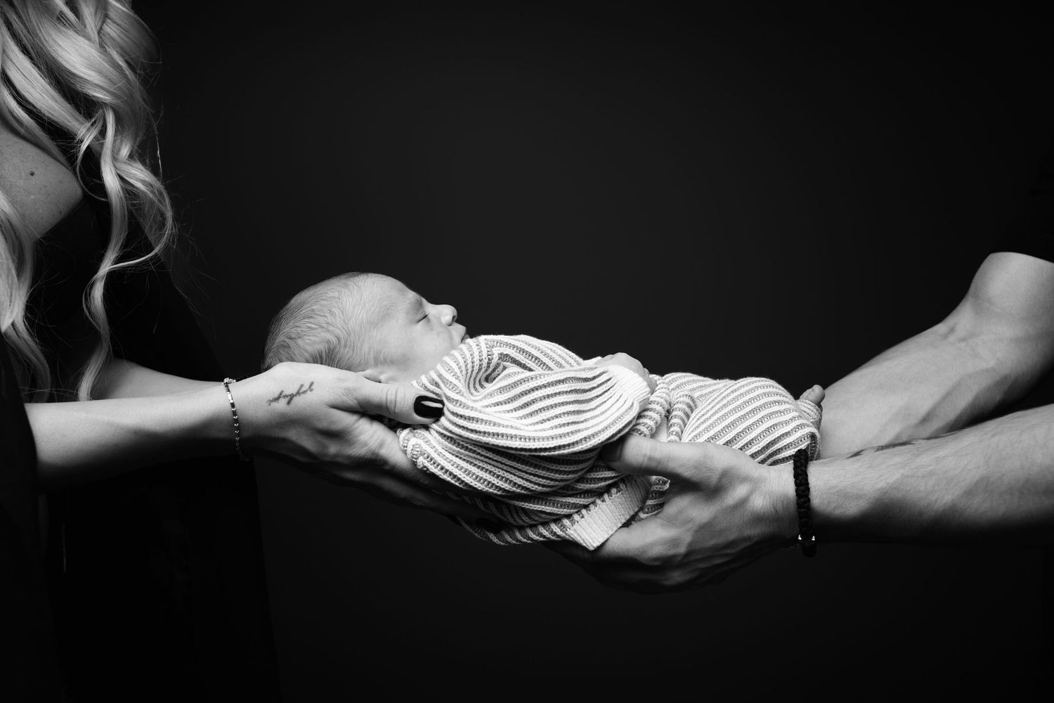 Black and white artistic photo series showing hands reaching and connecting in dramatic lighting.