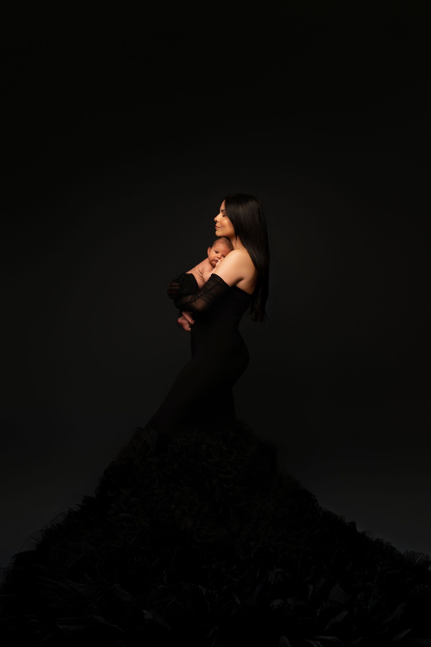 Silhouette of a person in black dress against dark background creating dramatic artistic poses in photo sequence.