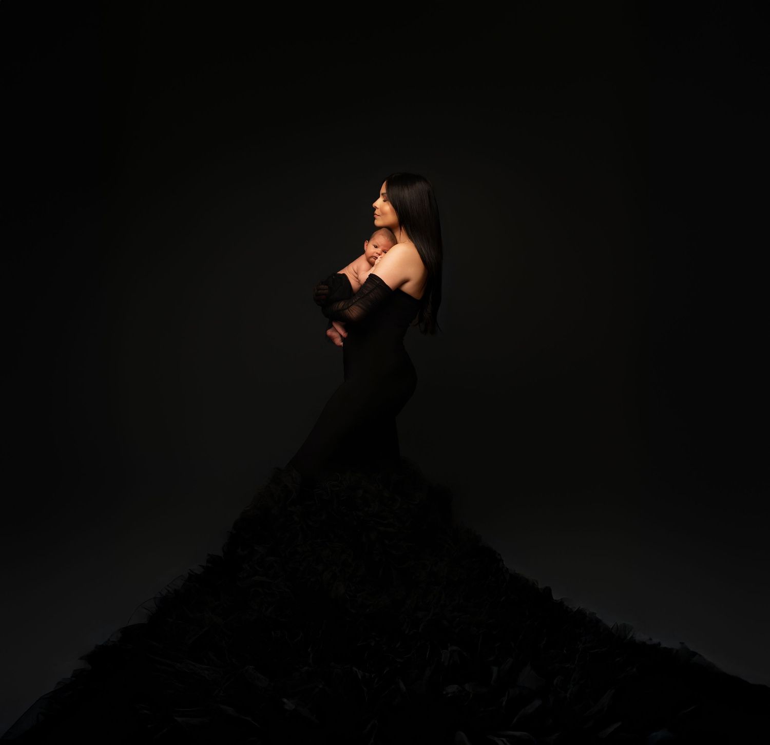 Silhouette of person with camera photographing against dark background in dramatic lighting sequence.