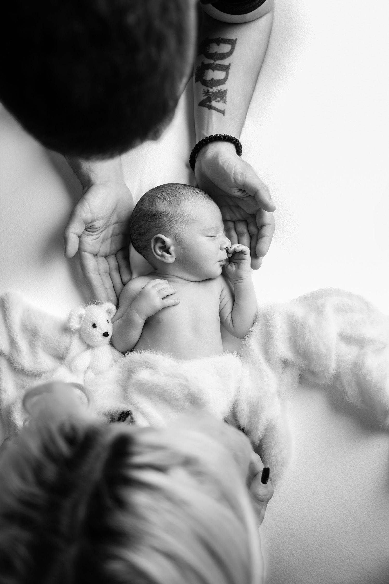 A series of black and white photos showing intimate moments of breastfeeding between parent and newborn.