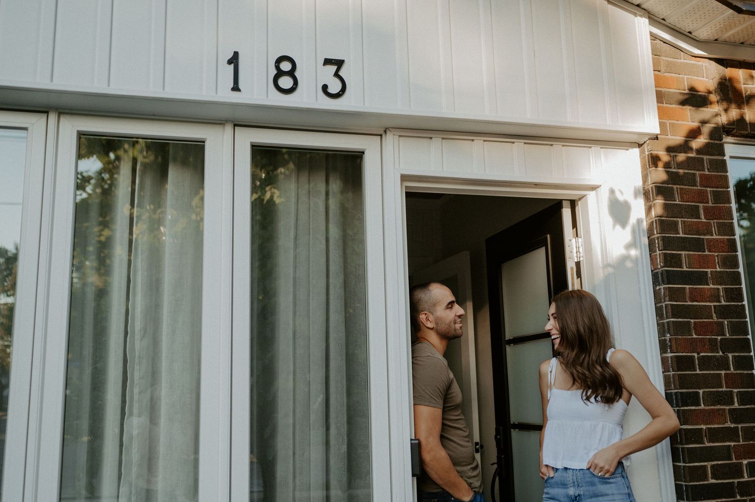 Two people having a conversation in the doorway.