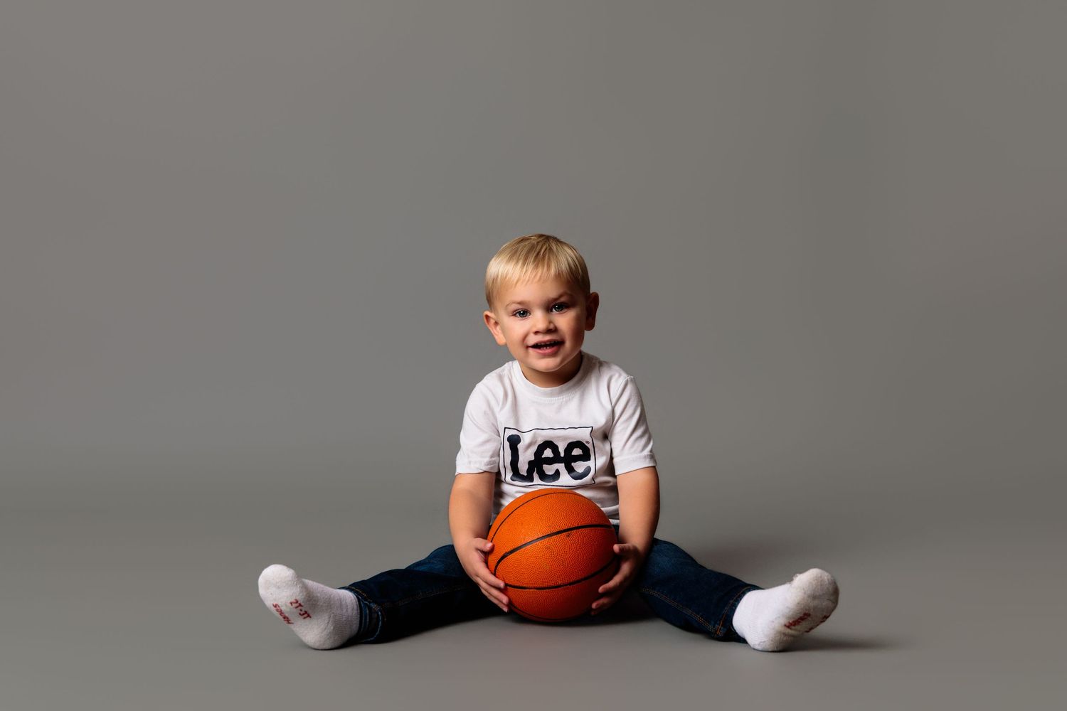 Playful poses with basketball showing movement and energy in studio setting.