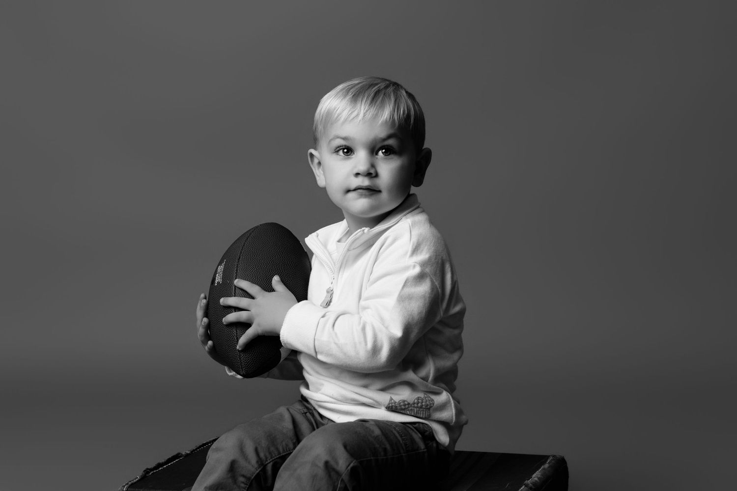 Black and white studio portraits capturing dynamic poses and joyful moments.