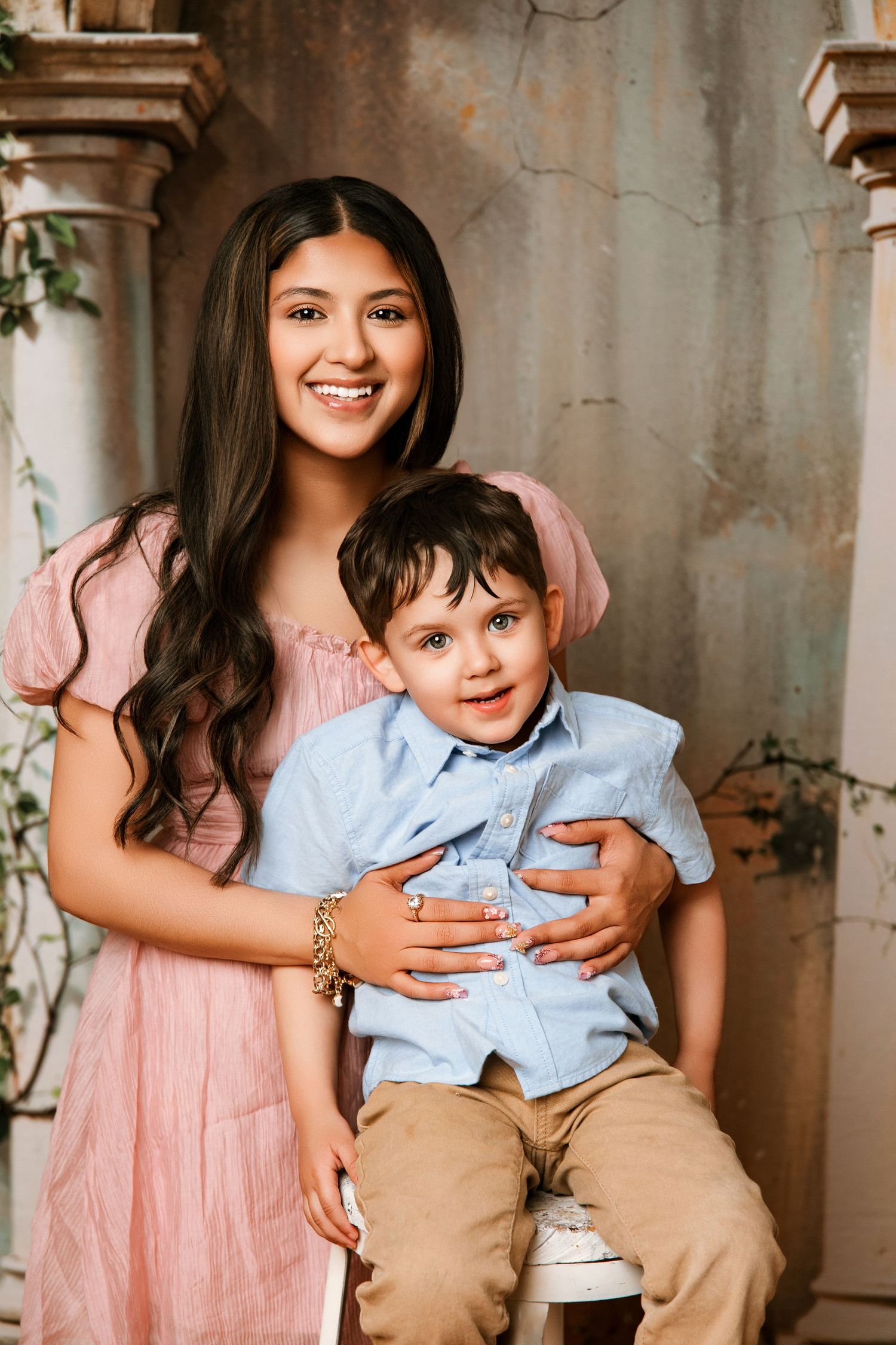 A heartwarming series of candid moments between a parent and child wearing pink and blue outfits against a rustic backdrop.