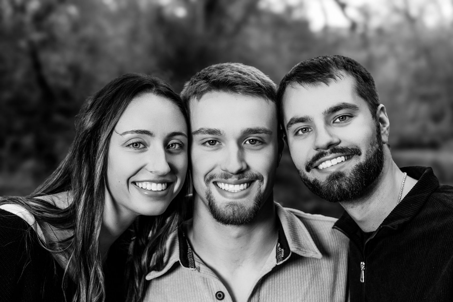 Black and white close-up portraits showing joyful expressions and laughter.
