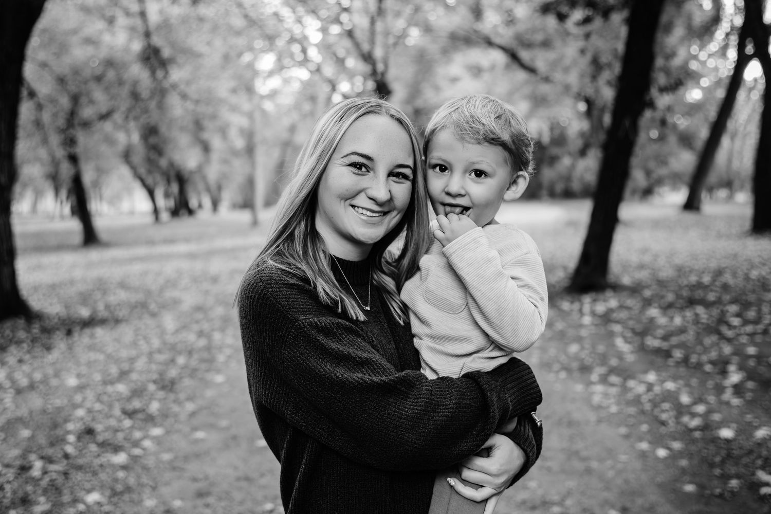 Black and white family portraits showing tender moments in an outdoor setting.