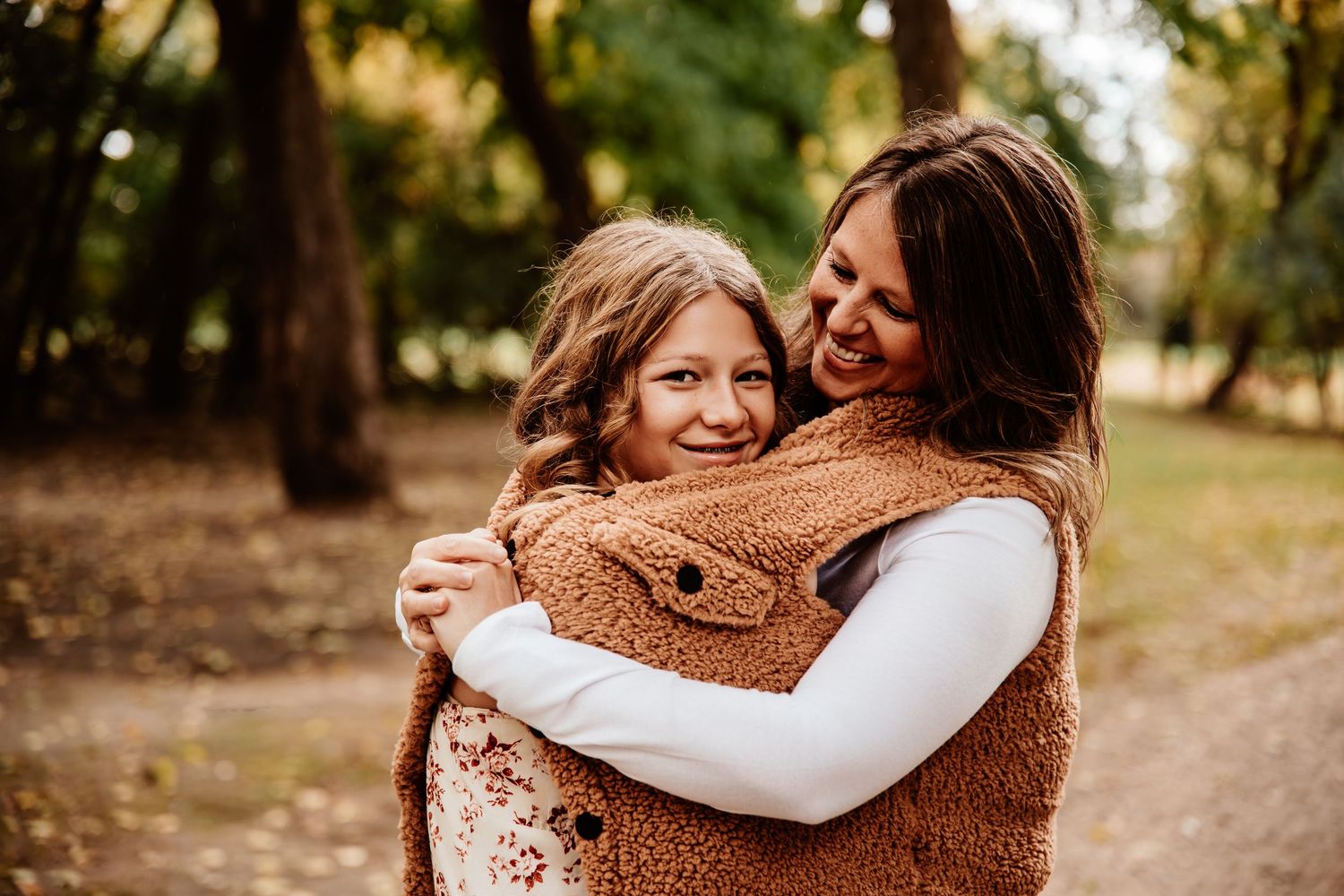 Candid moments of affection captured during an outdoor autumn family photo session.