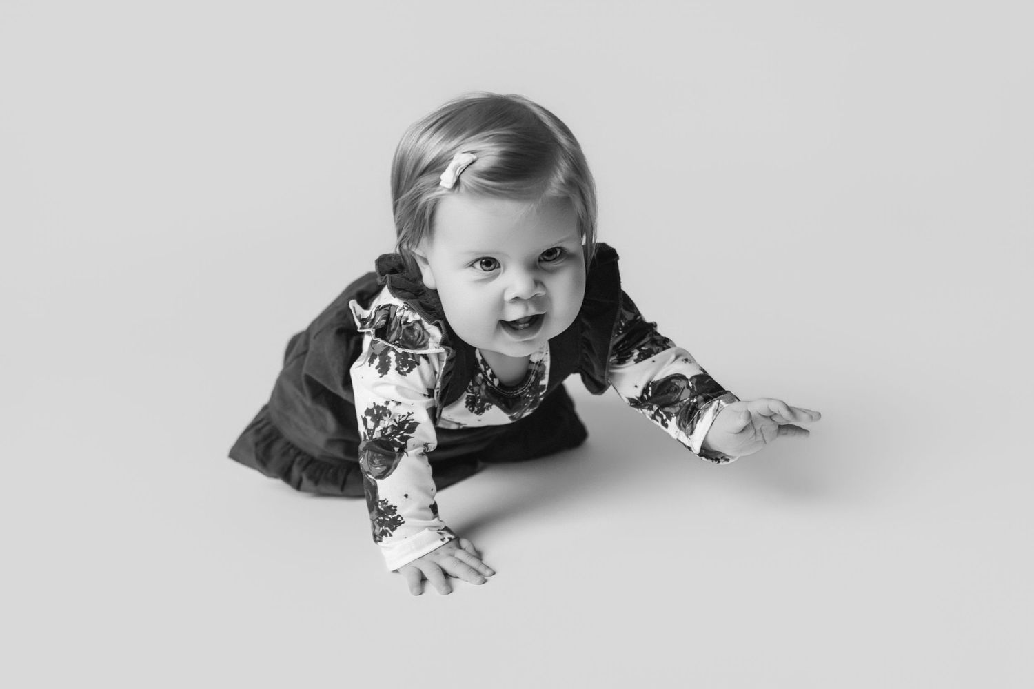Black and white series showing baby's movement across studio floor.
