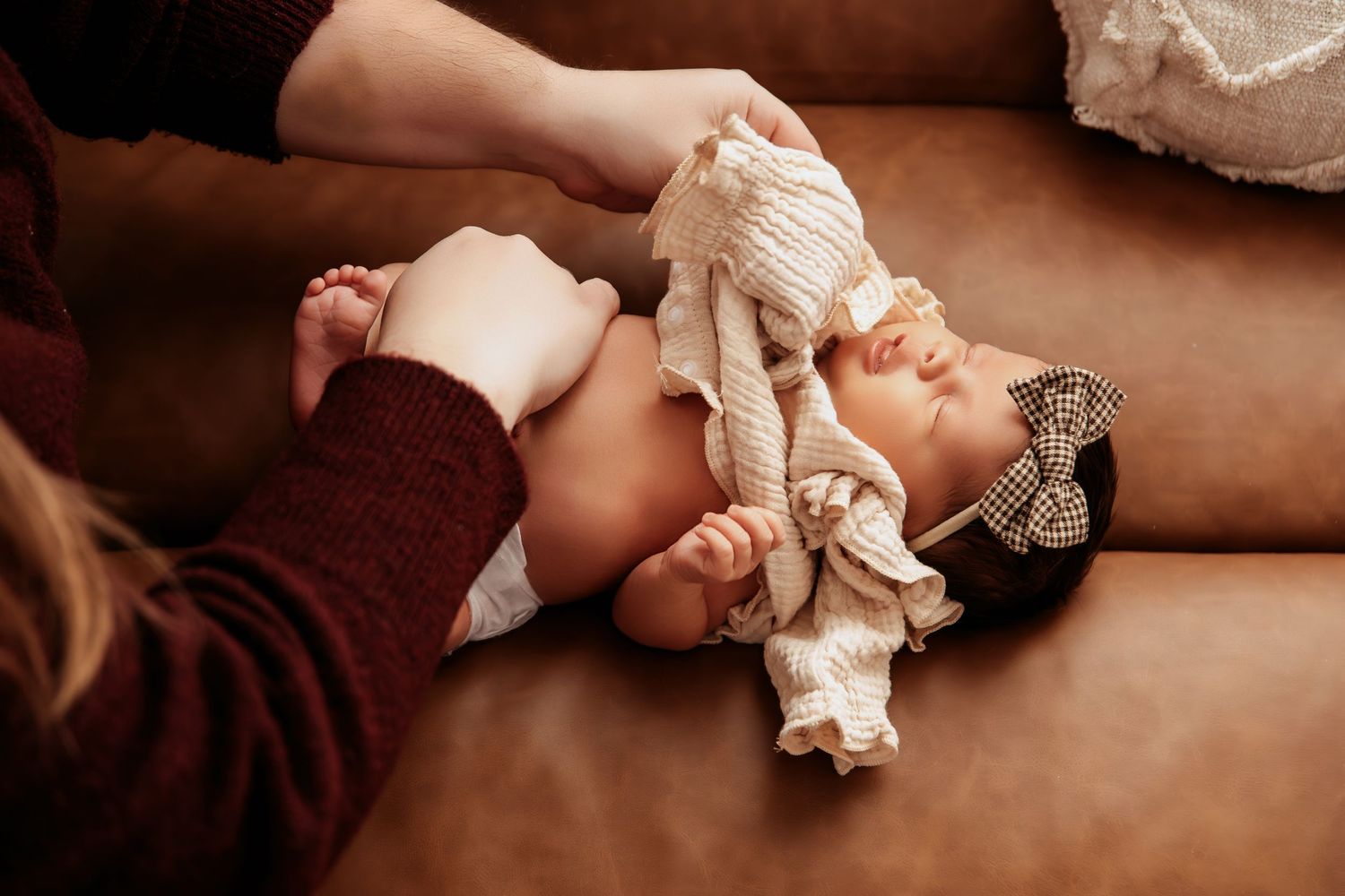 A series of close-up shots showing hands wringing out a wet white cloth or towel.