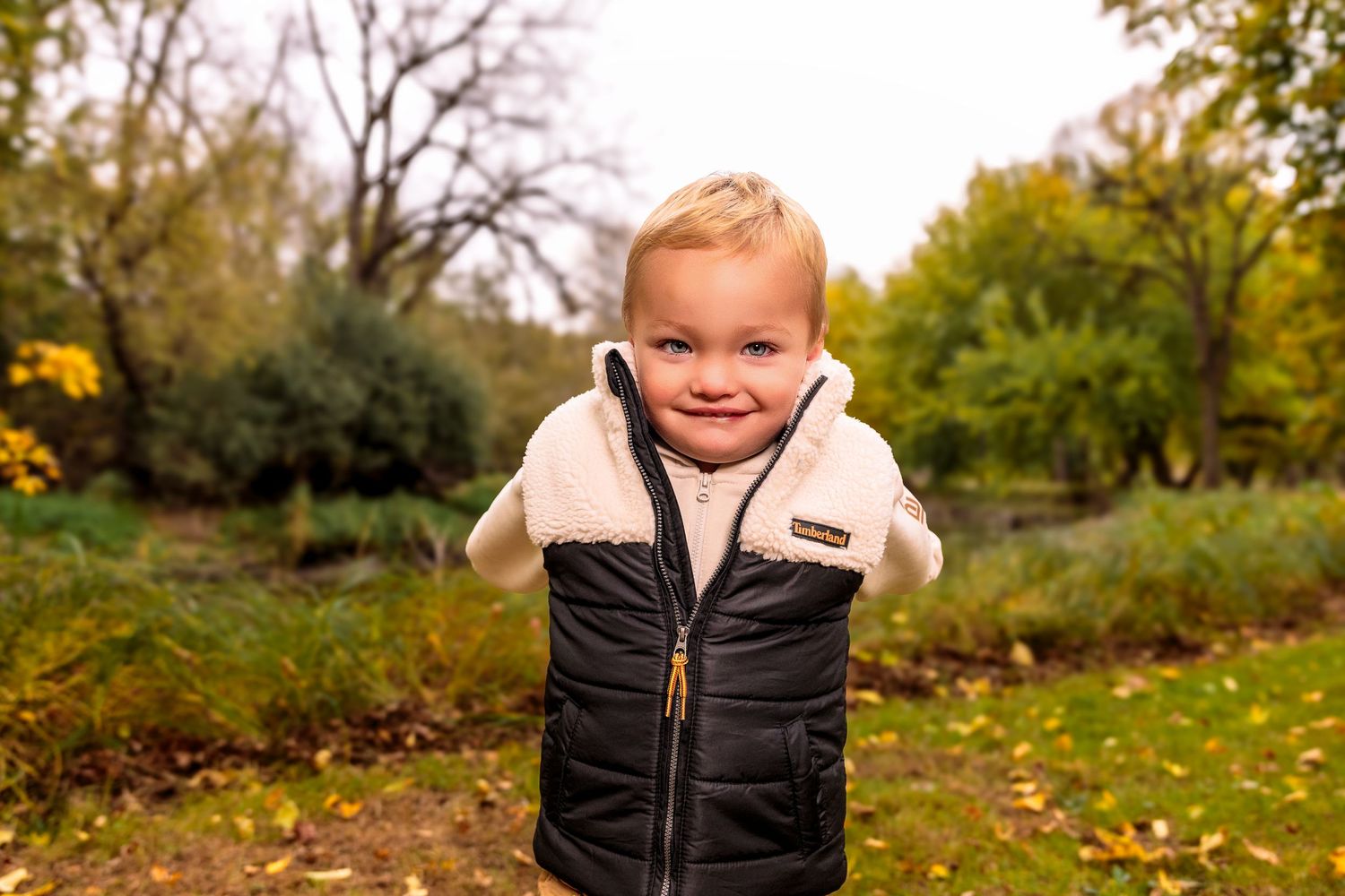 A series of fall outdoor photos showing someone wearing a black puffer vest and white shirt.