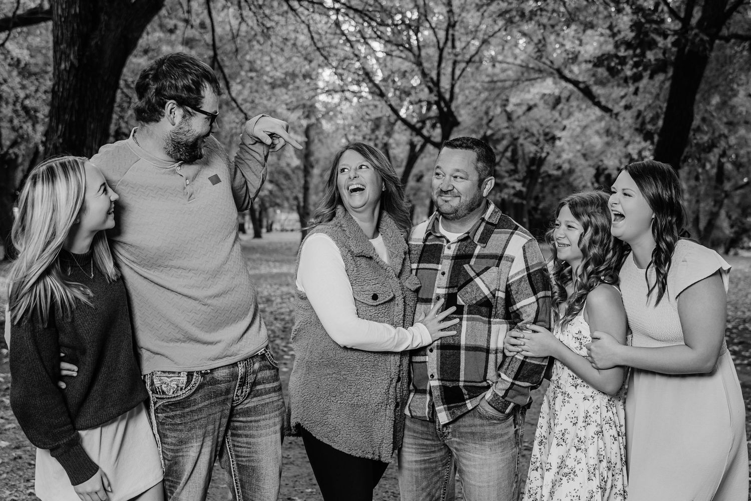 A group of friends sharing joyful moments together outdoors on a sunny day.