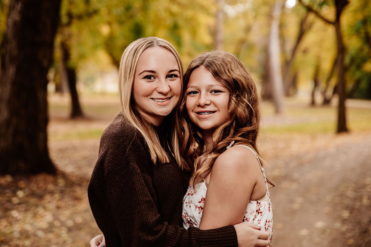 Intimate family portrait session captured in warm autumn lighting outdoors.