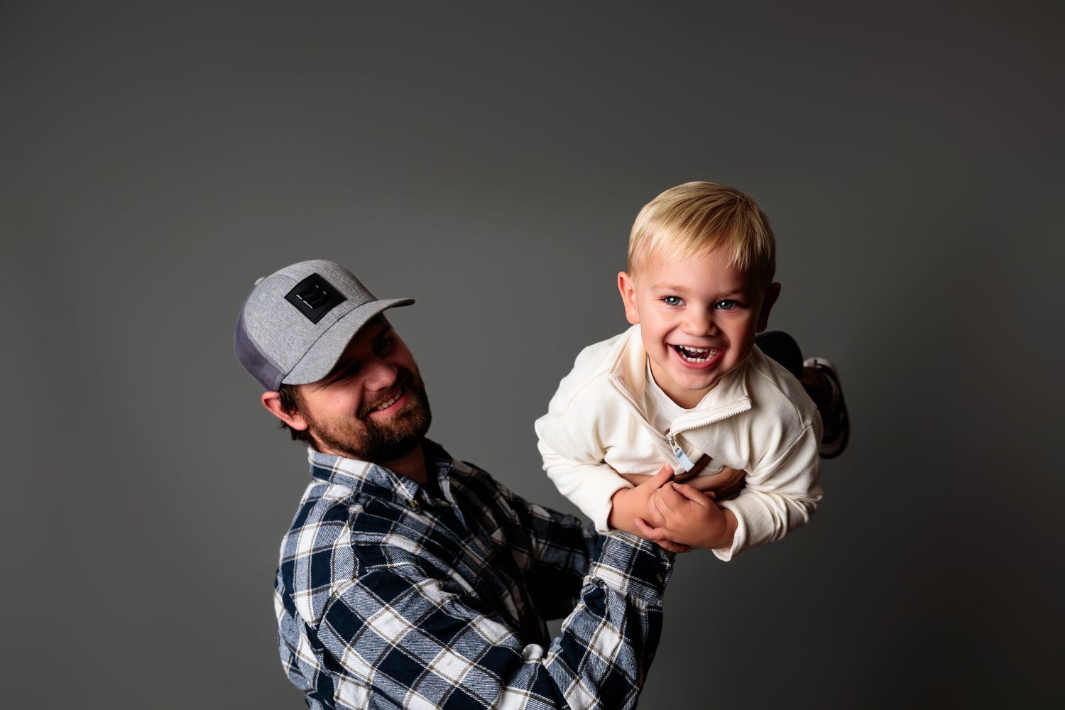 Candid black and white studio shots showing joyful interaction between two people.