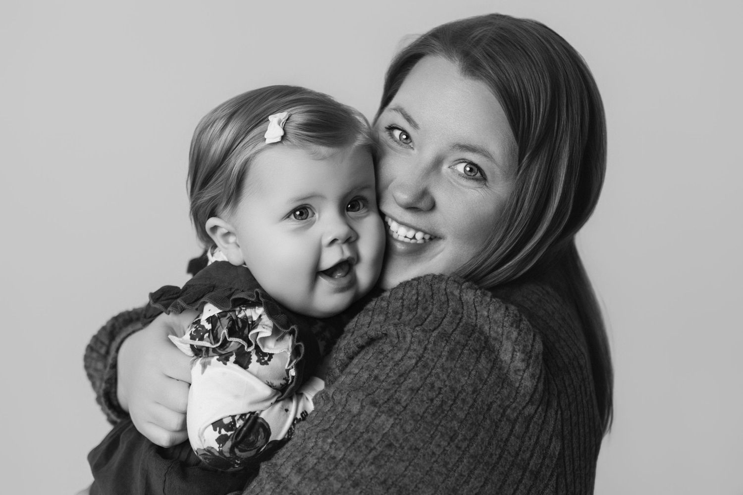 Series of intimate black and white portraits showing parent-child bonding moments.